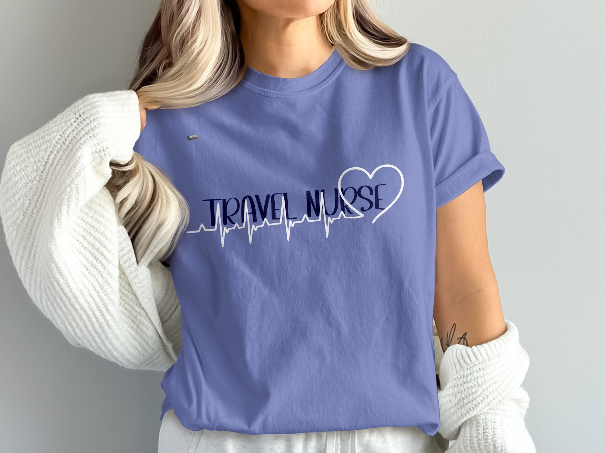 Periwinkle t-shirt with "TRAVEL NURSE" and a heart-shaped EKG graphic.