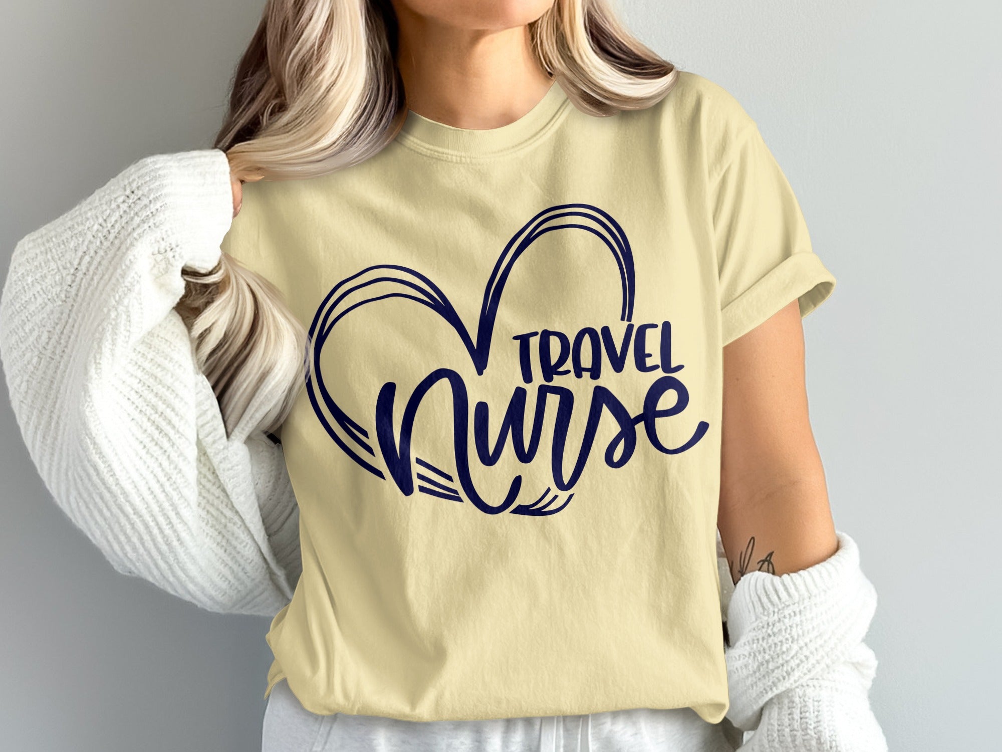 Light yellow t-shirt with dark blue "Travel Nurse" heart graphic.