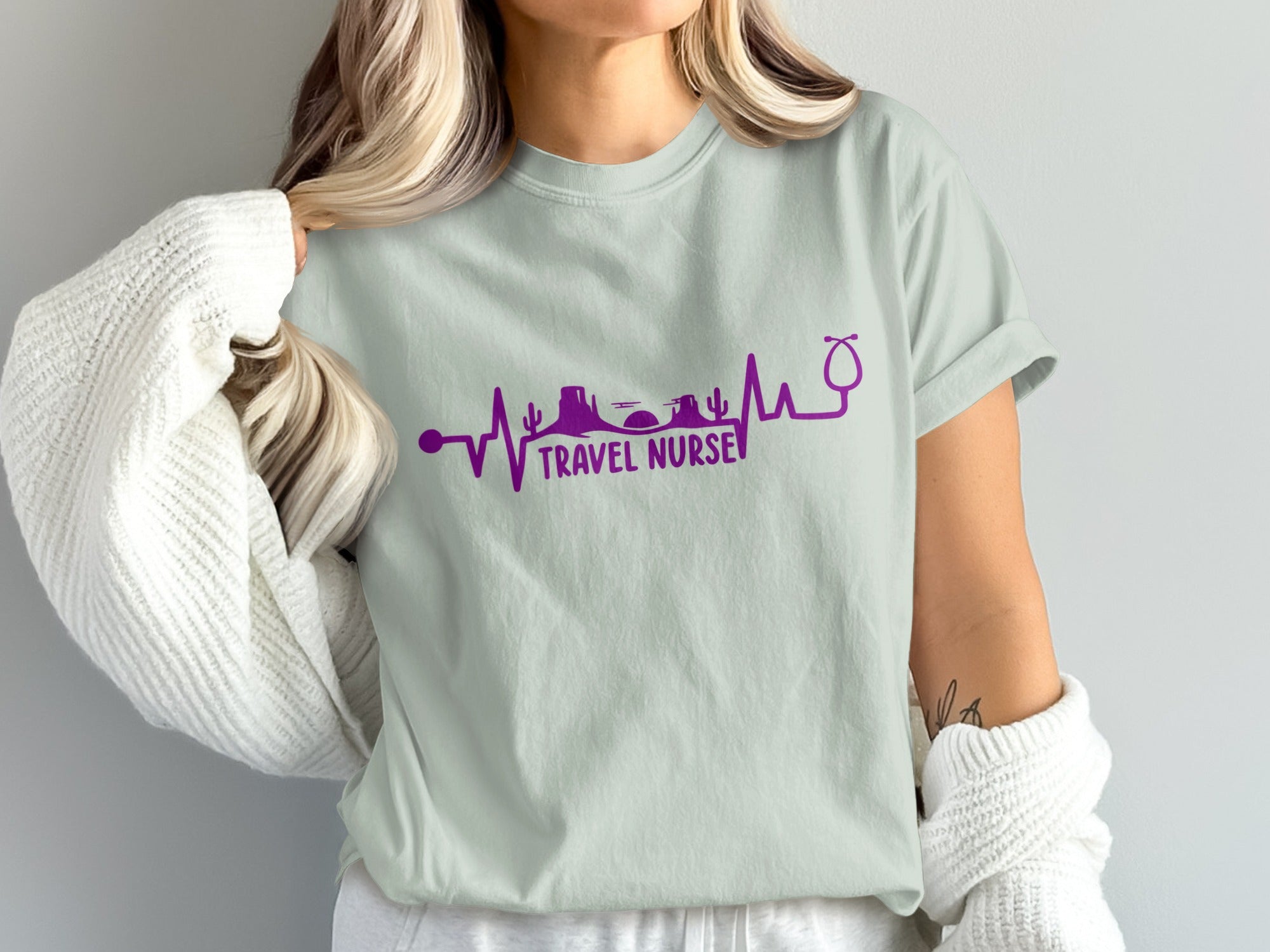 Light teal t-shirt with purple heartbeat design and "TRAVEL NURSE" text.