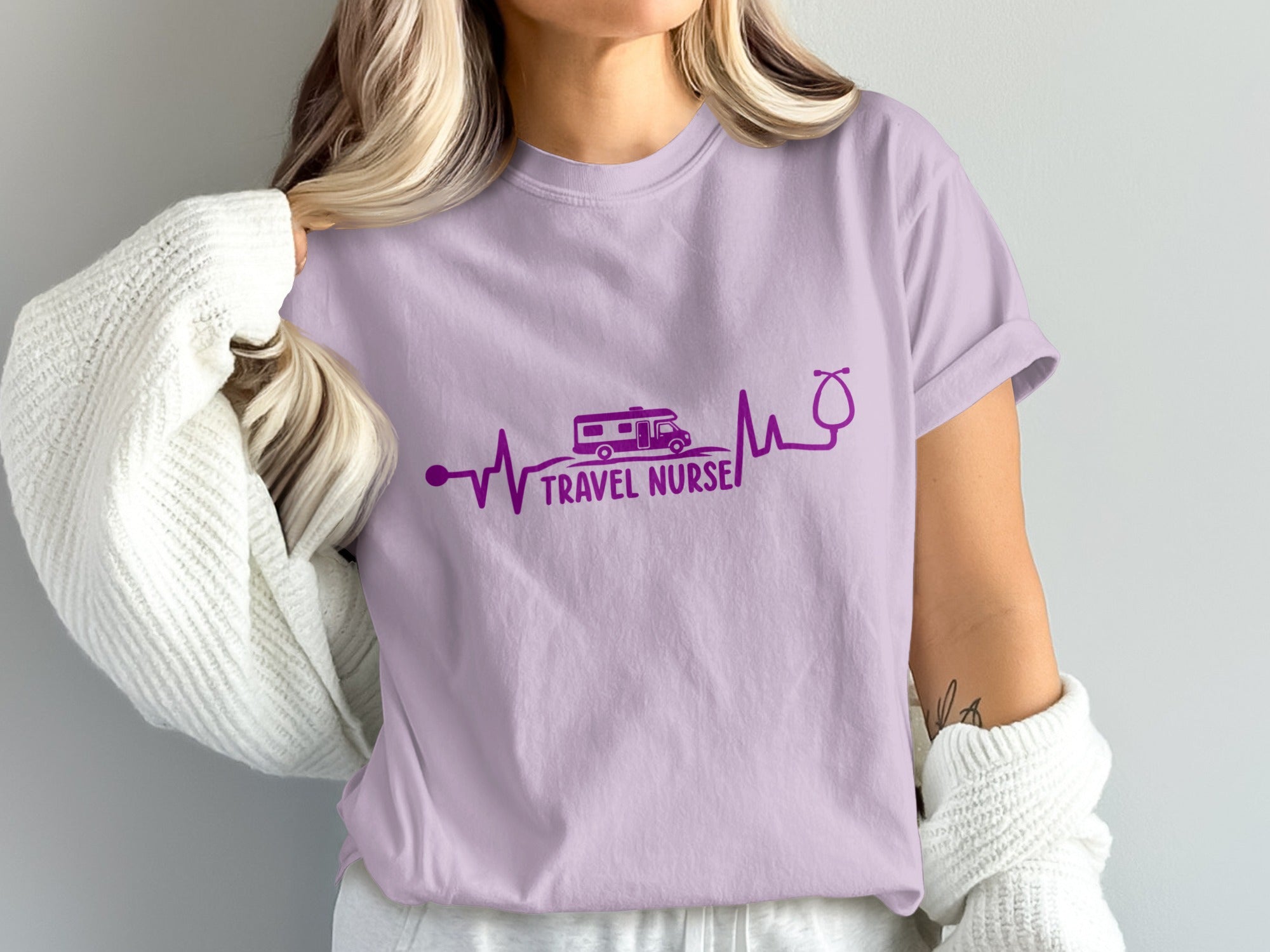Purple t-shirt with "Travel Nurse" text, RV, and stethoscope on a heartbeat line.