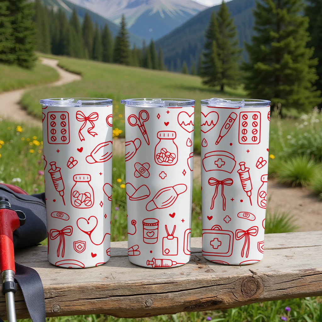 Three white tumblers with red medical icons and lids, on a wooden surface.