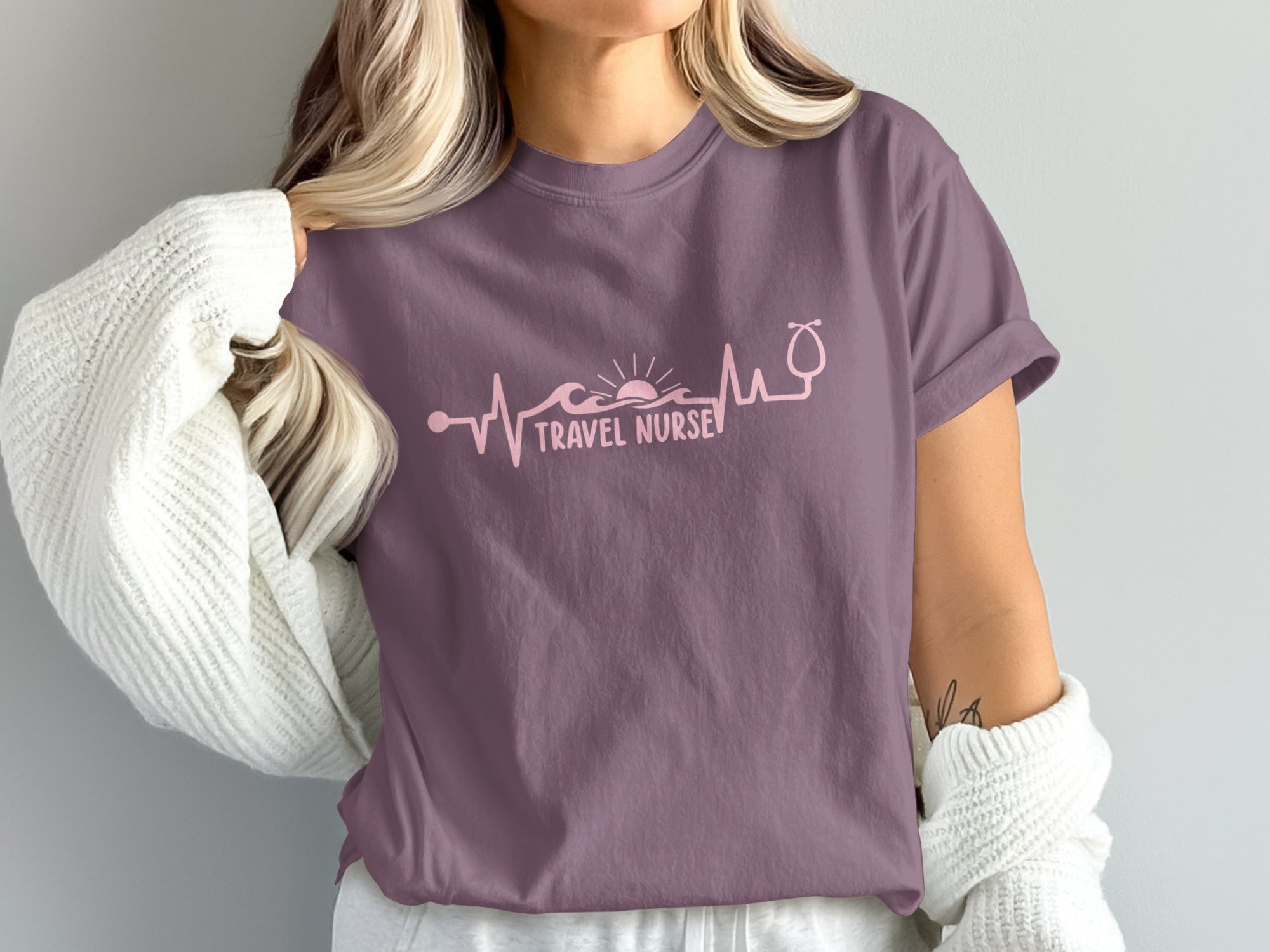 Mauve t-shirt with pink "Travel Nurse" electrocardiogram design including a stethoscope and sun.