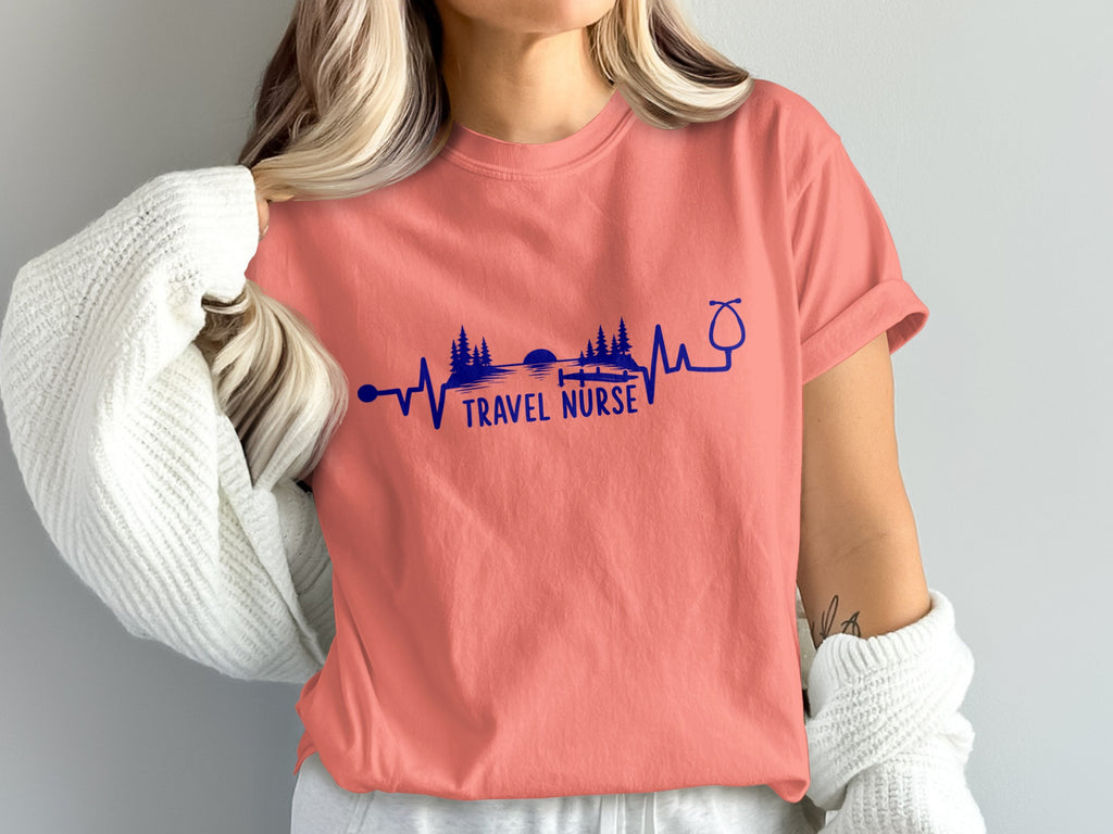 Salmon t-shirt with "Travel Nurse" text and landscape heartbeat graphic.