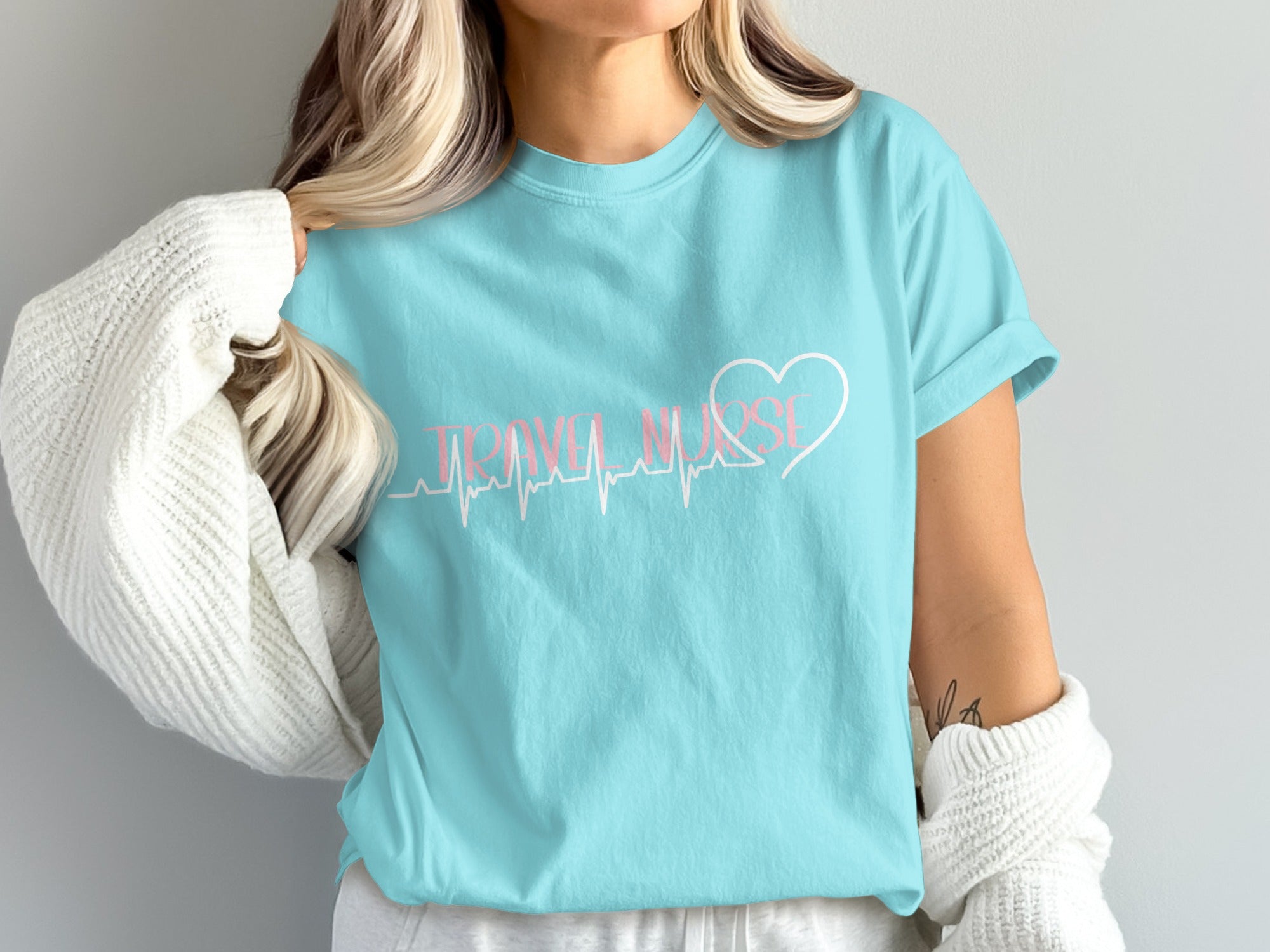 Light blue t-shirt with "TRAVEL NURSE" and a heartbeat line graphic.