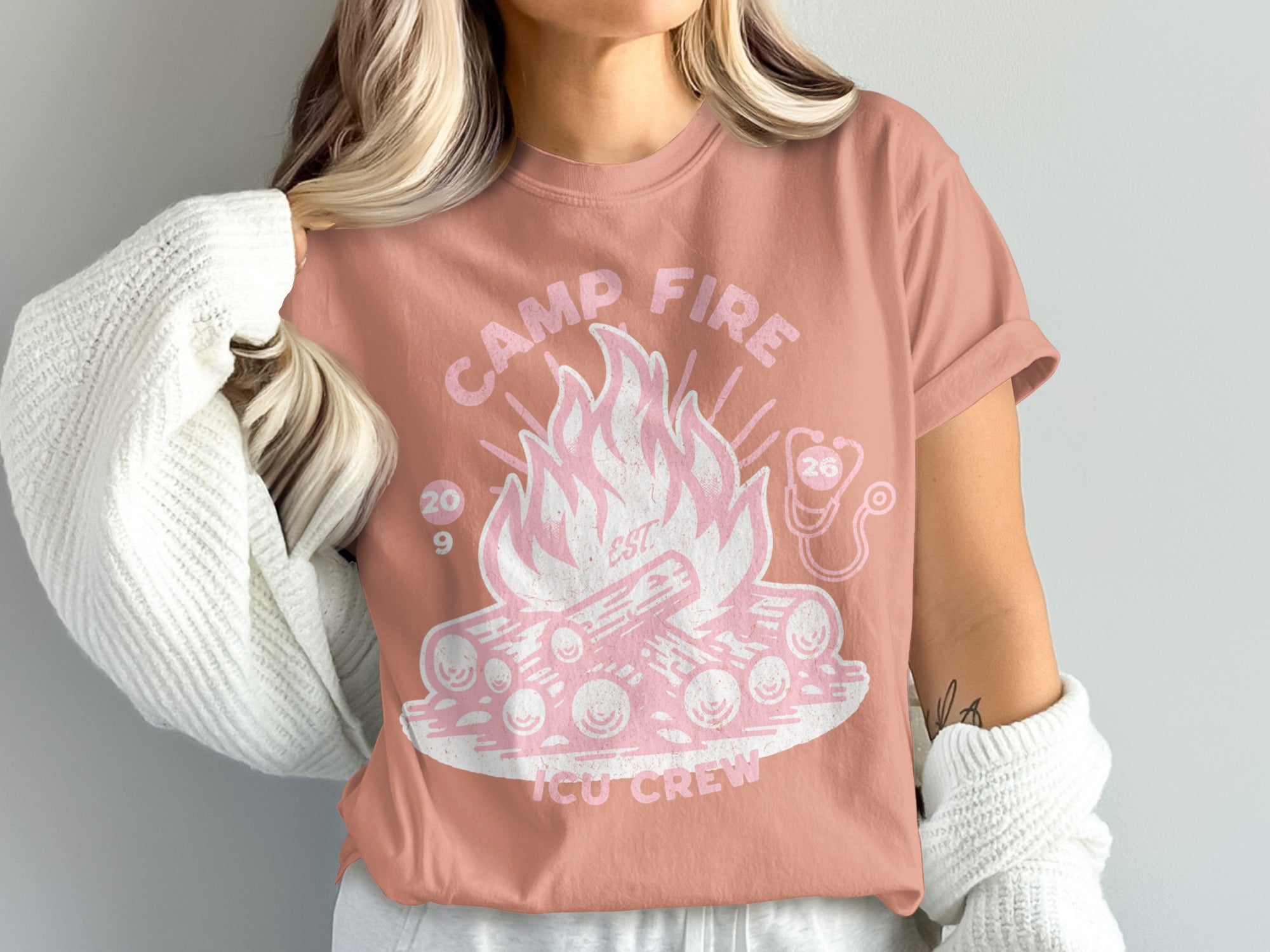 Pink t-shirt with campfire graphic and "ICU Crew" text.