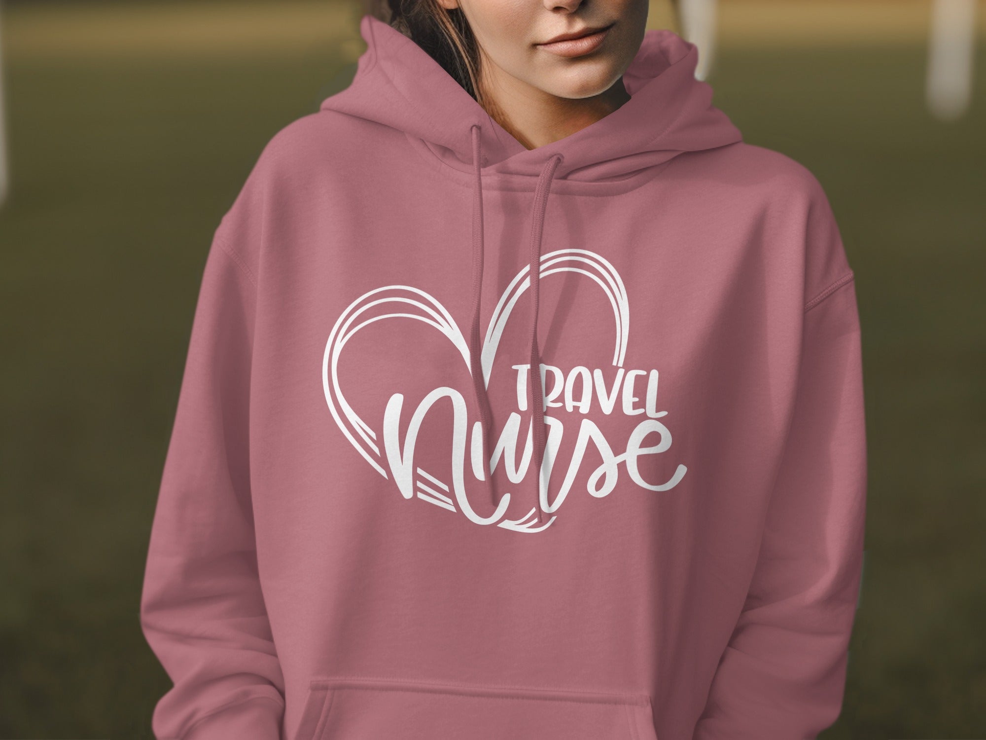 Pink hoodie with "TRAVEL NURSE" text inside a heart outline.
