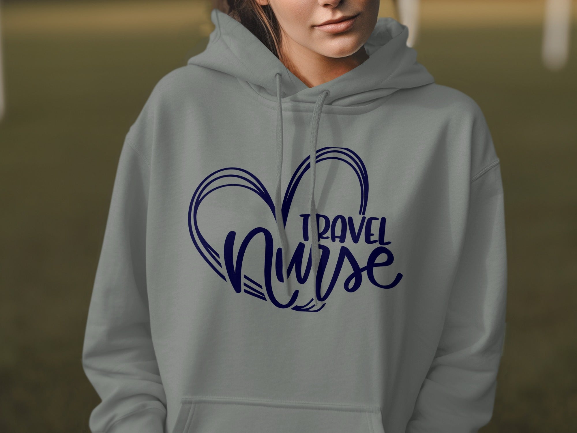 Grey hoodie with navy blue "Travel Nurse" heart graphic design.