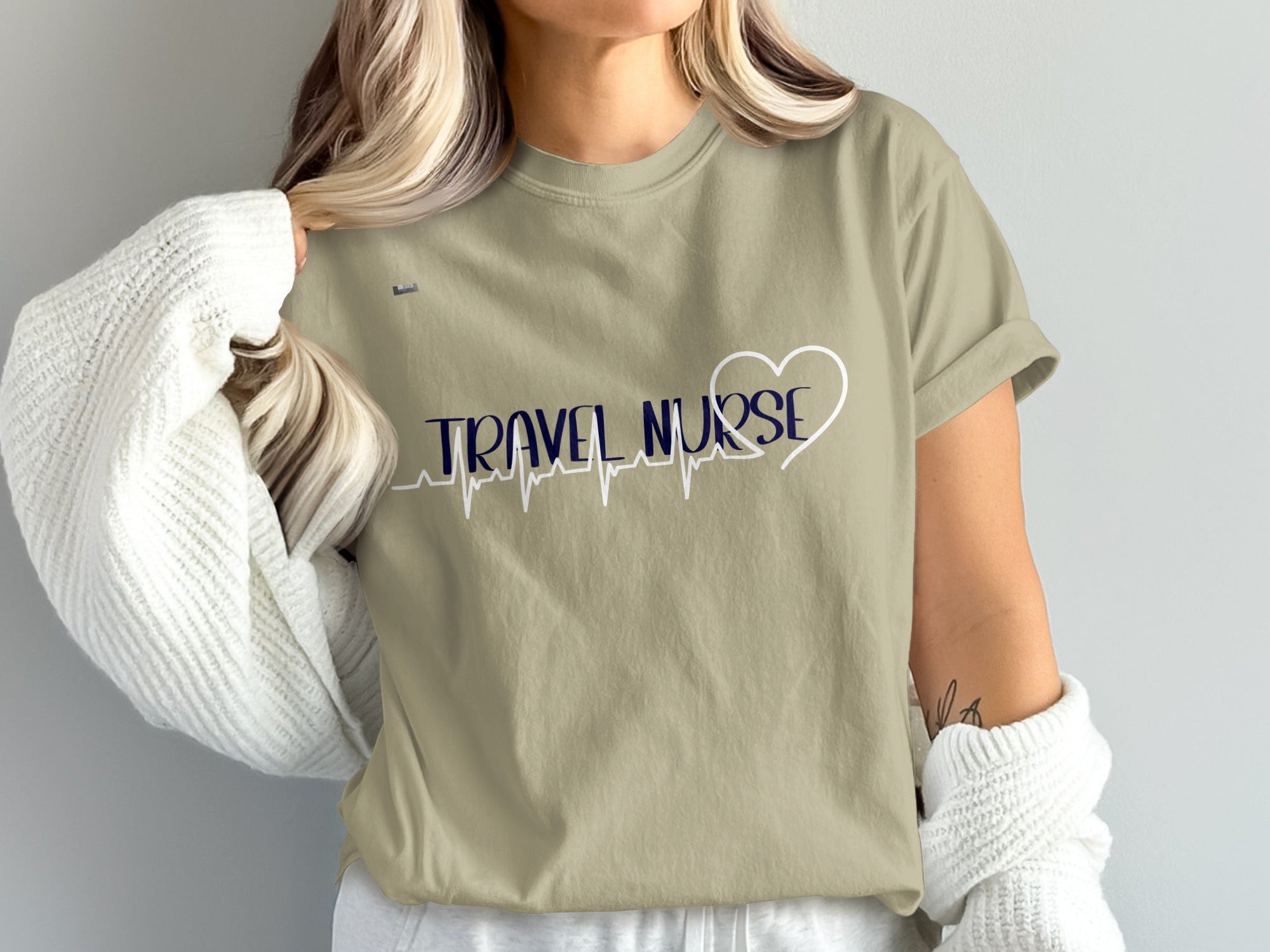 Tan t-shirt with "TRAVEL NURSE" and heart heartbeat graphic.
