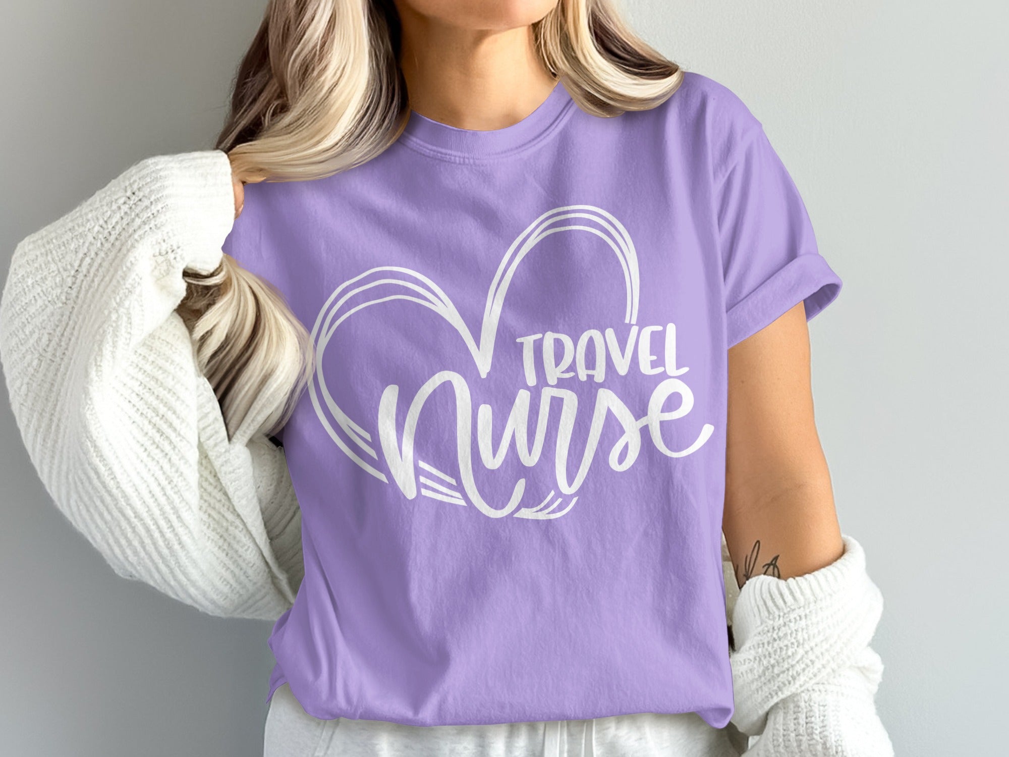 Purple t-shirt with white "Travel Nurse" heart graphic.