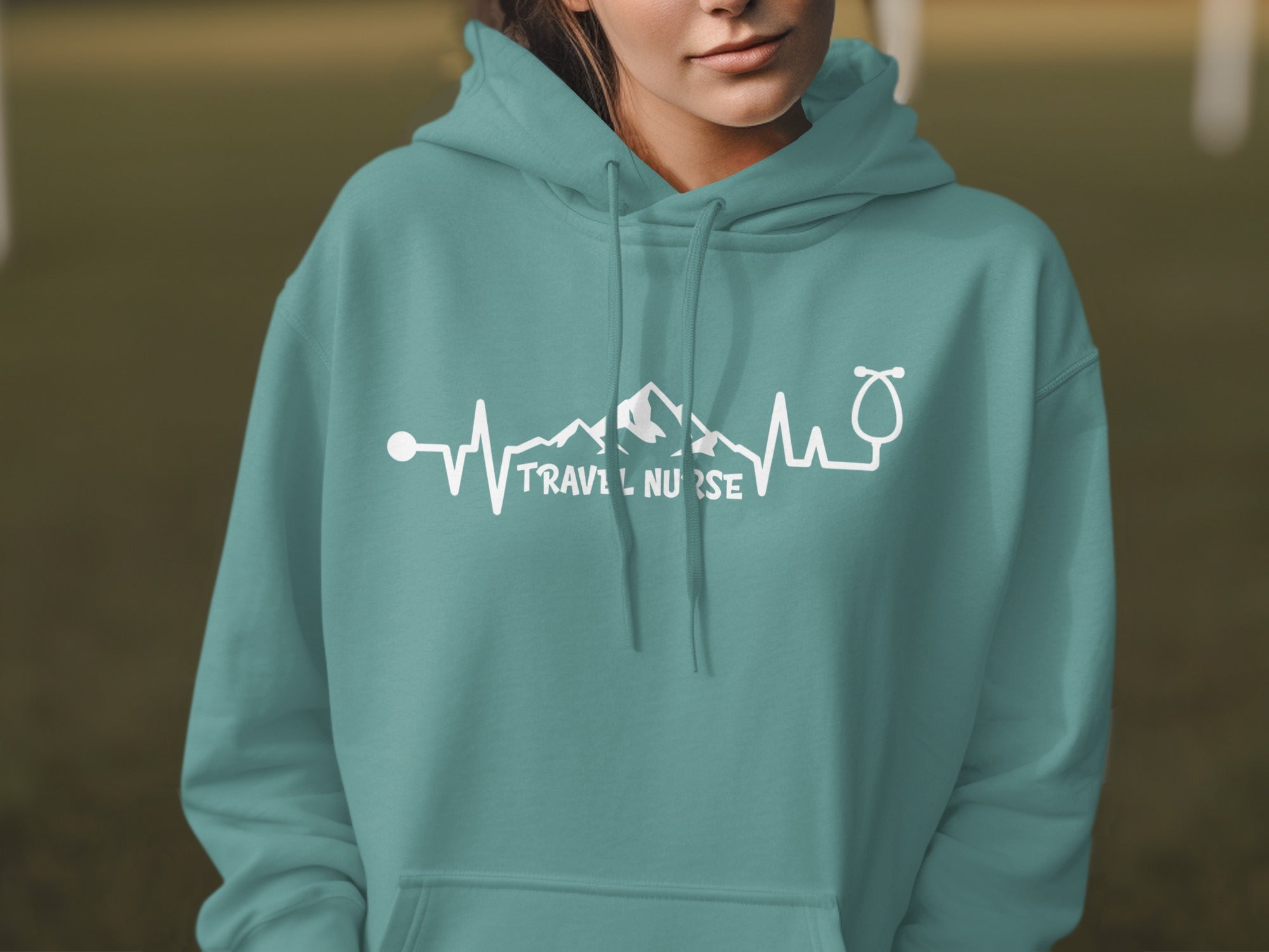Teal hoodie with "TRAVEL NURSE" and a mountain heartbeat design.