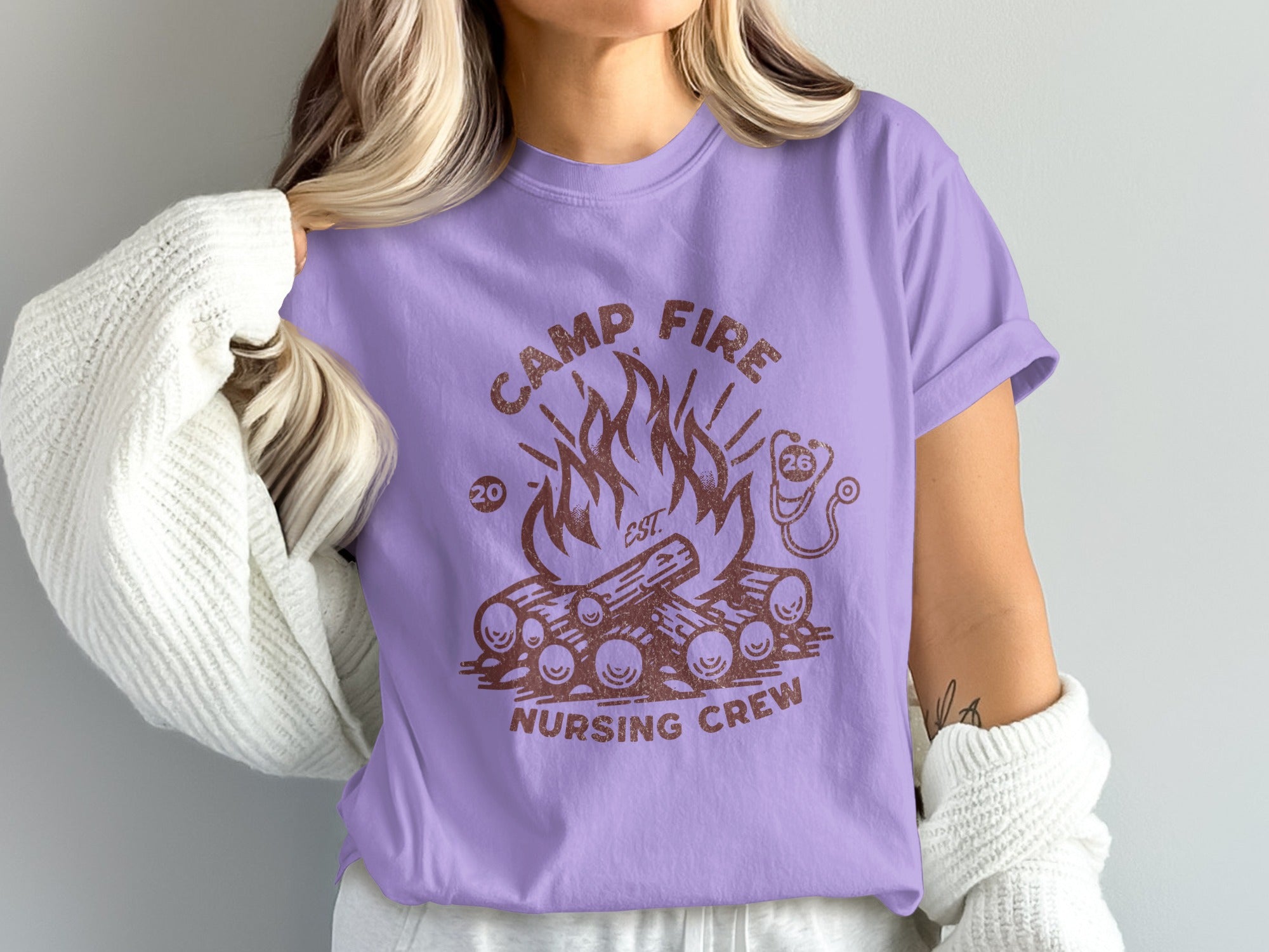 Purple t-shirt with campfire and "Camp Fire Nursing Crew" text.