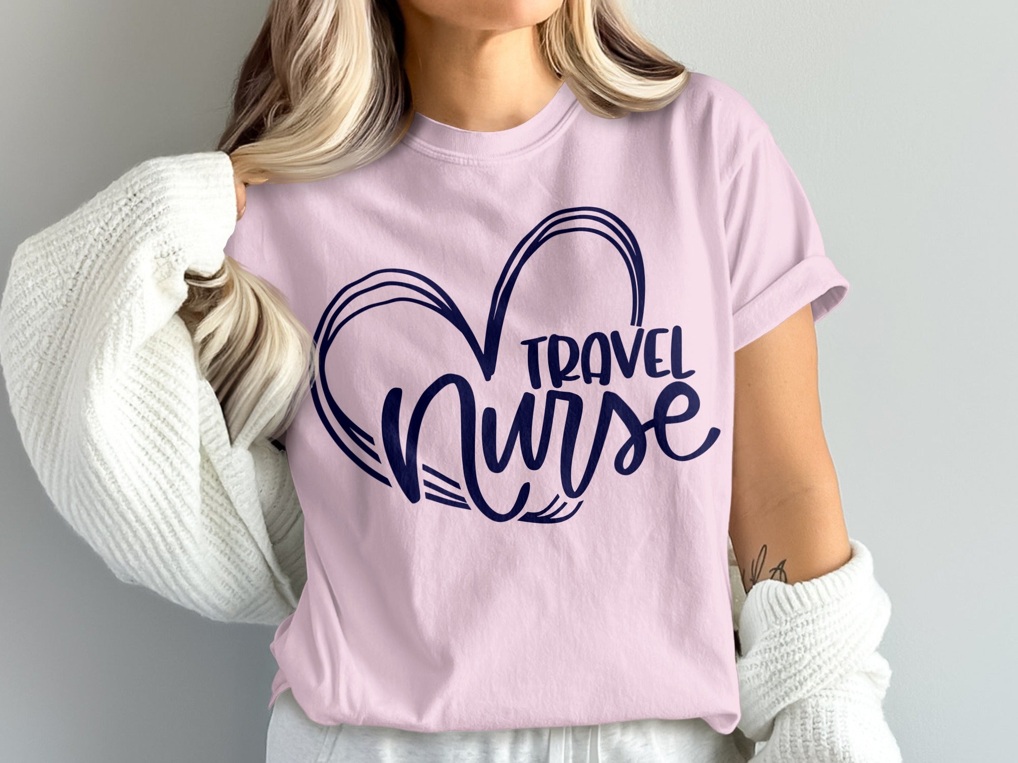 Pink t-shirt with "Travel Nurse" inside a heart graphic.