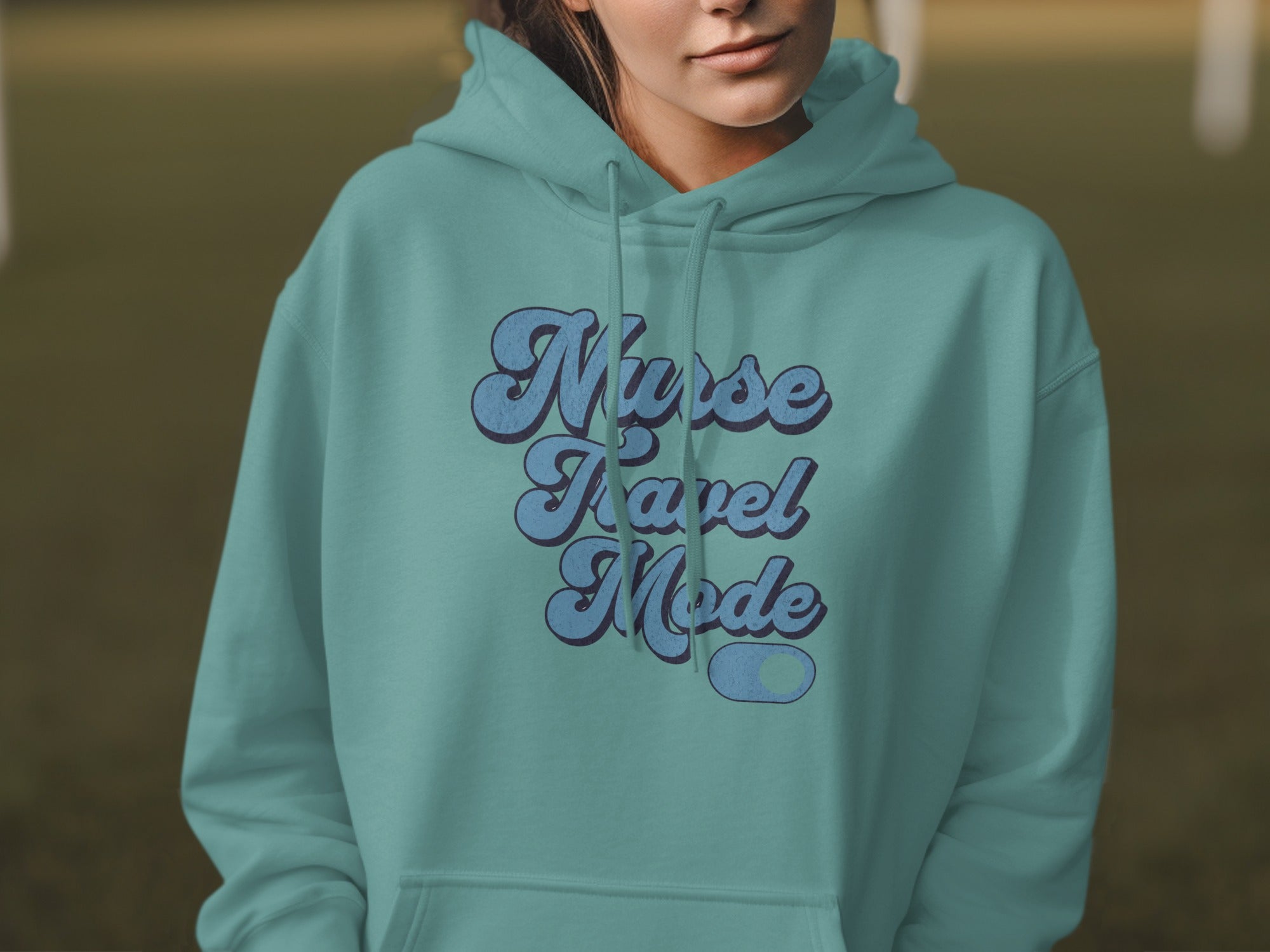 Teal hoodie with "Nurse Travel Mode" text in retro lettering.