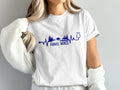 White t-shirt with navy blue "TRAVEL NURSE" text and medical design.