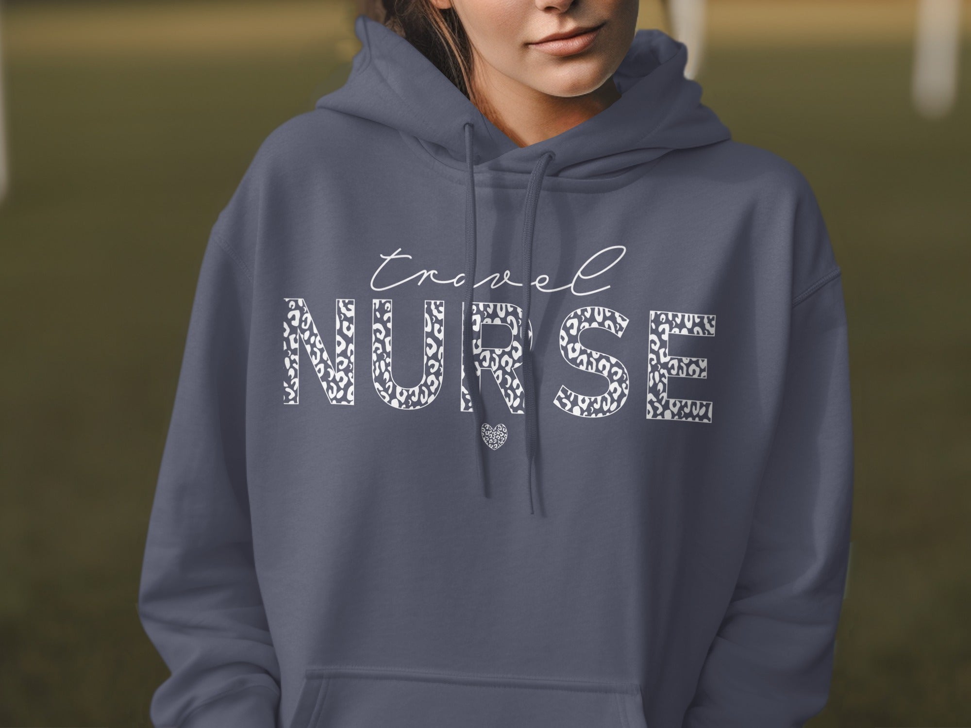 Dark gray hoodie with white leopard print "Travel Nurse" text.
