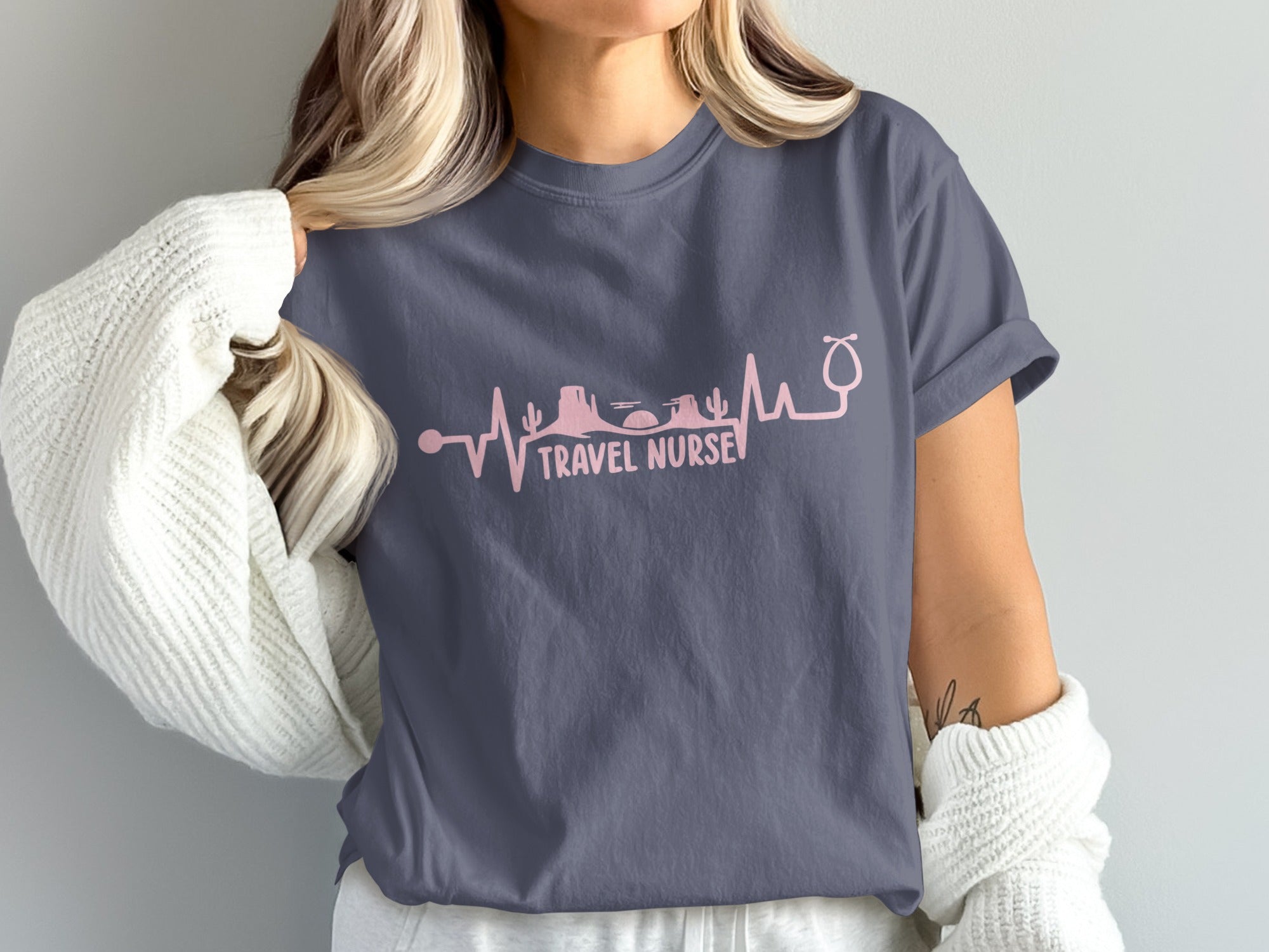 T-shirt with pink stethoscope and desert landscape heartbeat line.