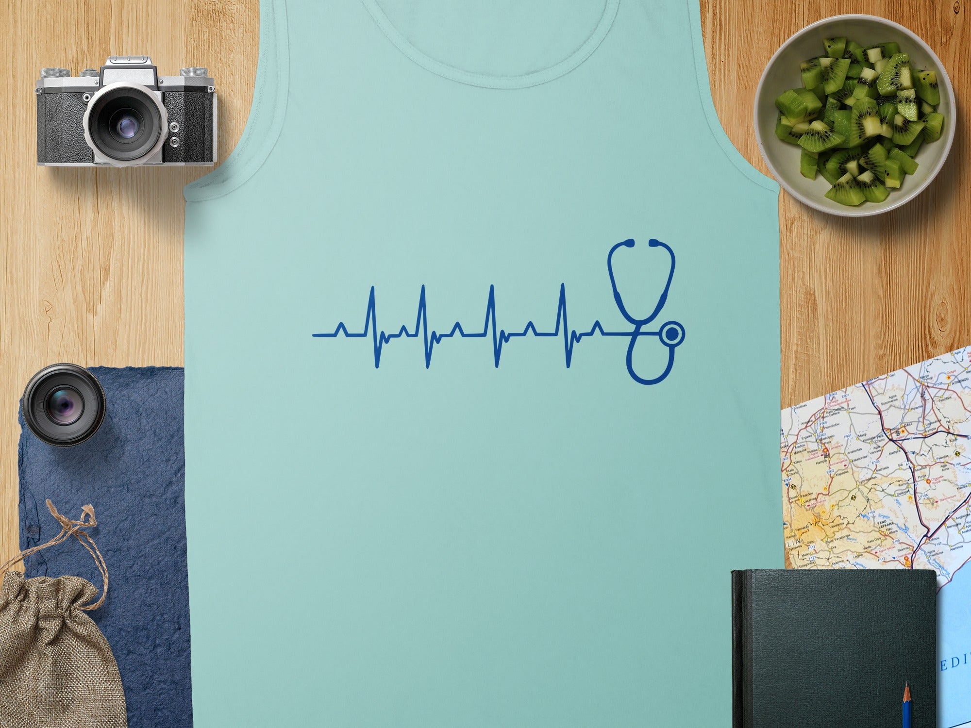 Light blue tank top with a dark blue stethoscope and heartbeat graphic.