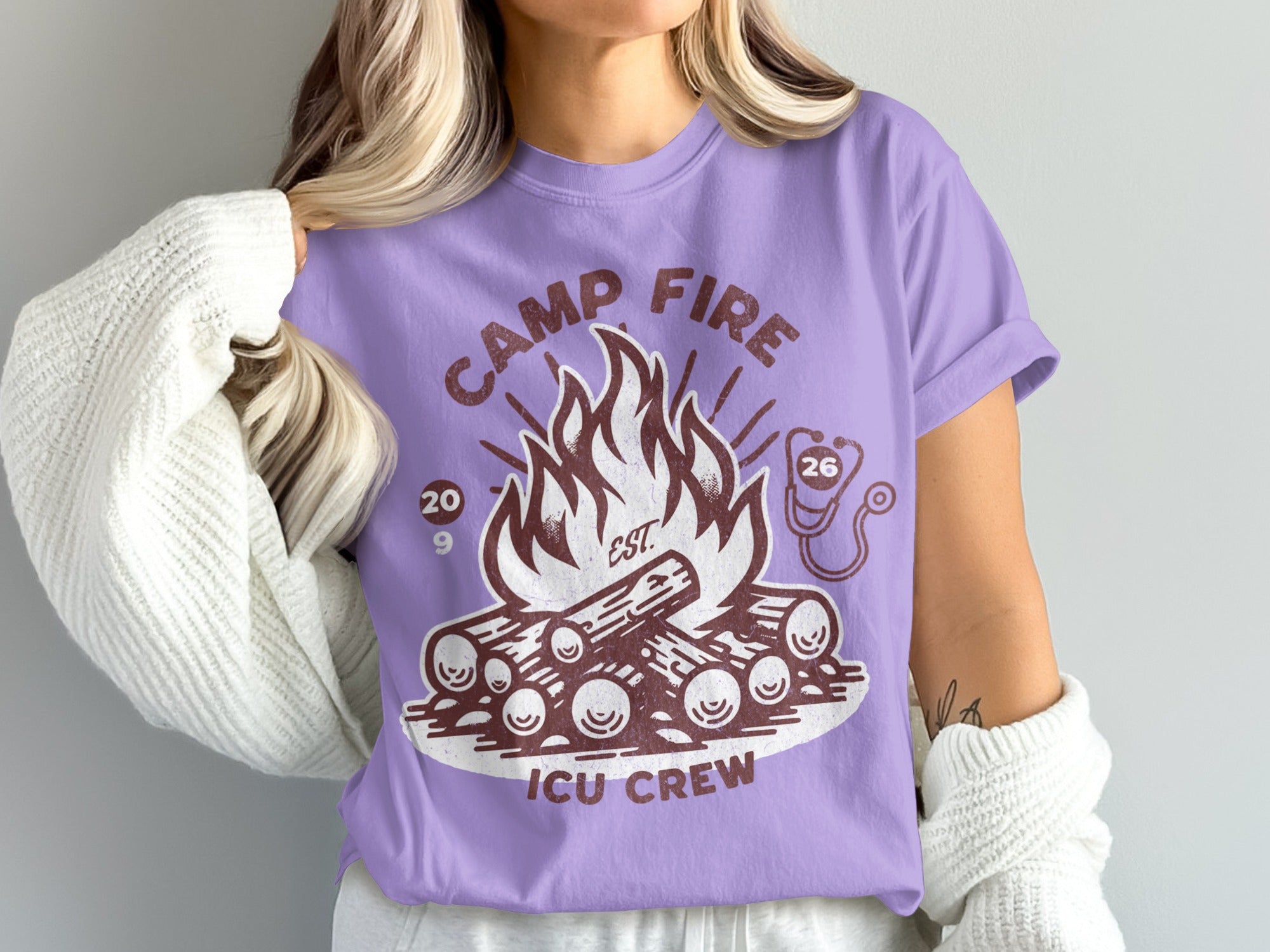 Camp Fire ICU Crew graphic on a purple t-shirt with stethoscope and dates.