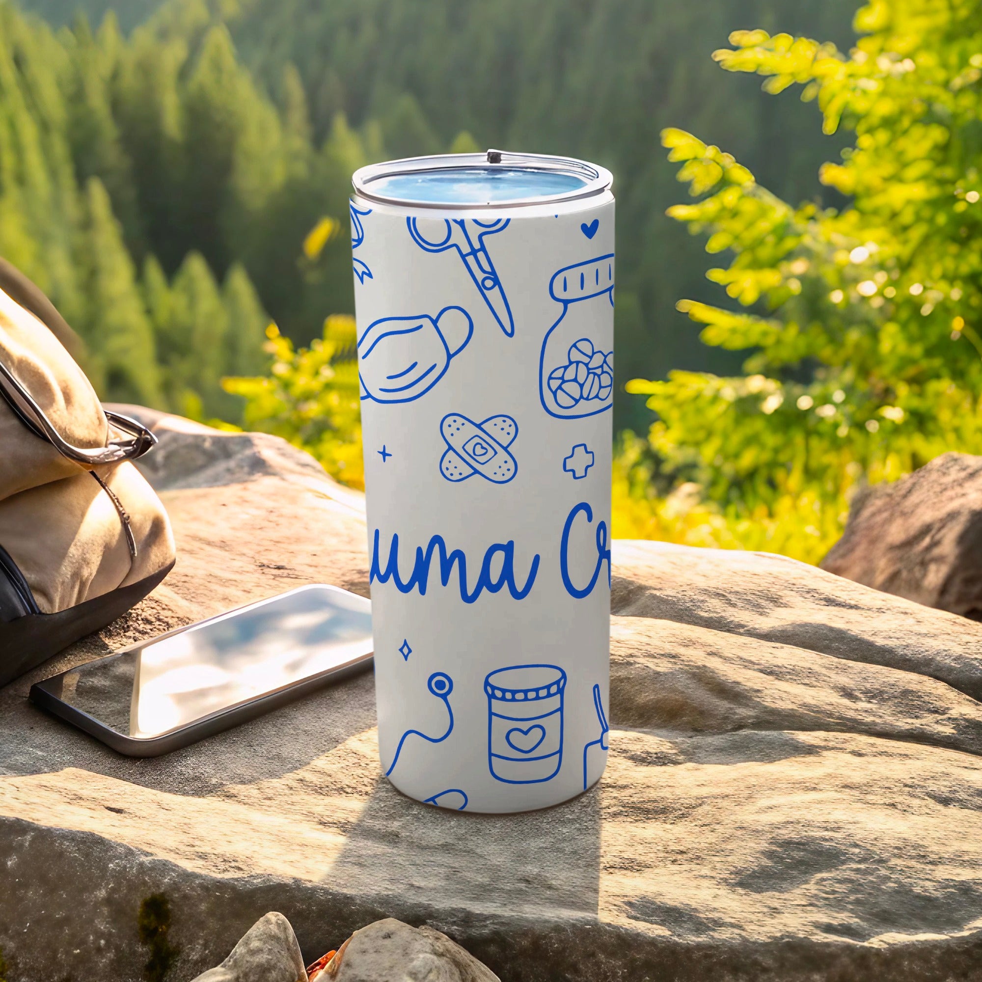 White tumbler with medical icons and "uma Cr" text, outdoors.