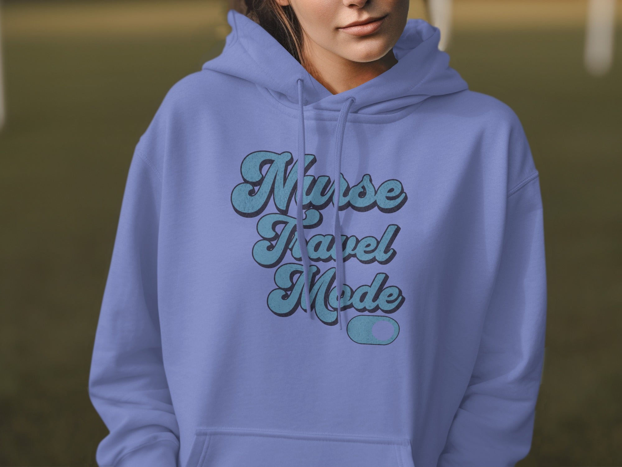 Purple hoodie with "Nurse Travel Mode" text in blue.