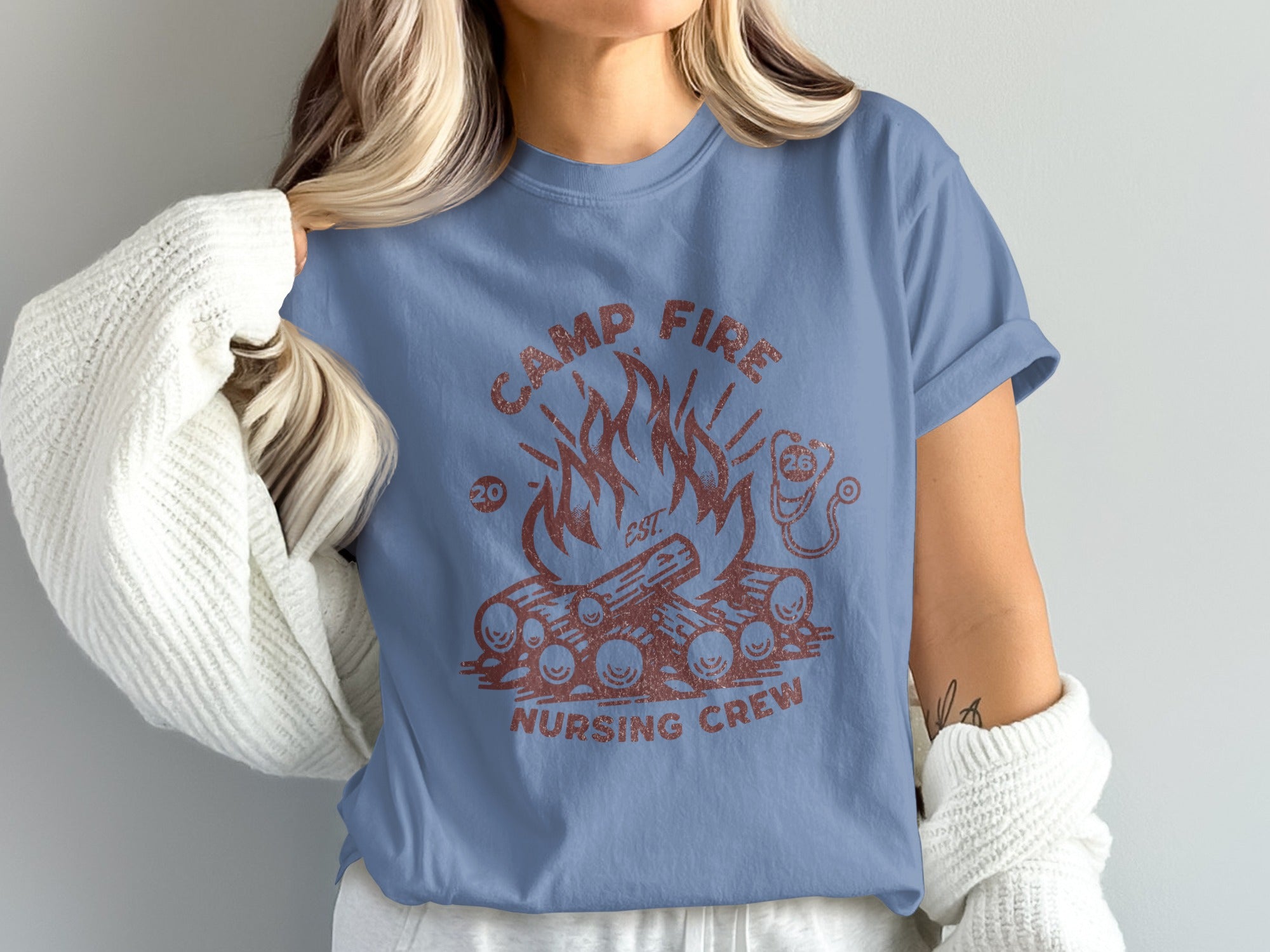 Camp Fire Nursing Crew text with campfire graphic on blue t-shirt.
