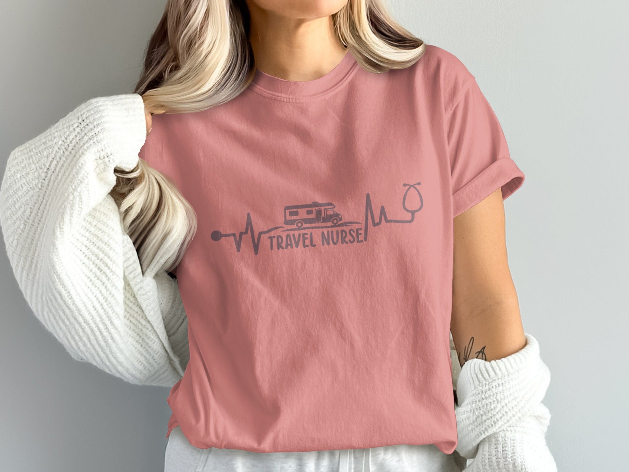 Pink t-shirt with "TRAVEL NURSE" text and heartbeat graphic featuring RV and stethoscope.