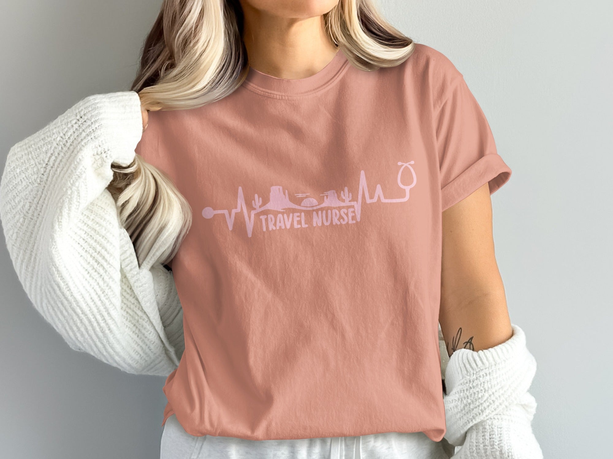 Dusty rose t-shirt with stethoscope skyline and "TRAVEL NURSE" text.