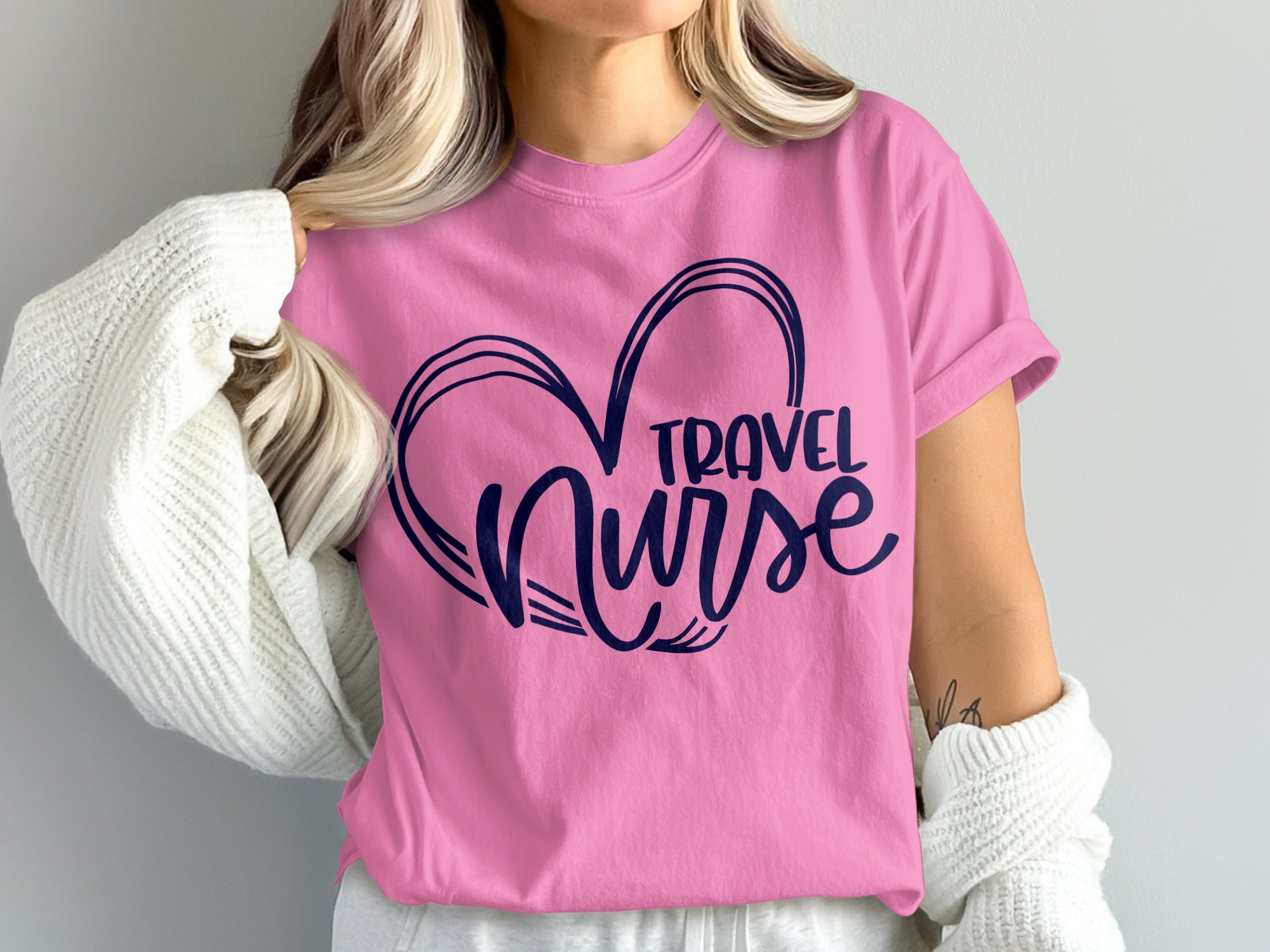 Pink t-shirt with navy blue heart outline and "TRAVEL NURSE" text.