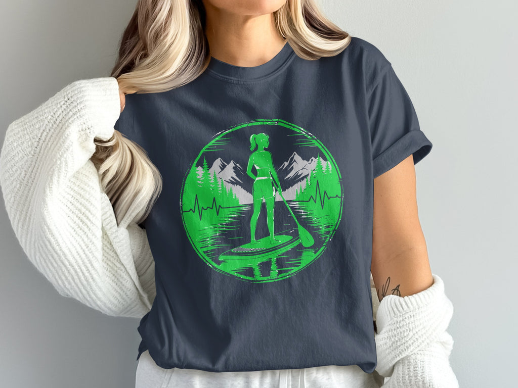 Woman on paddleboard with mountains and trees in green circle graphic.