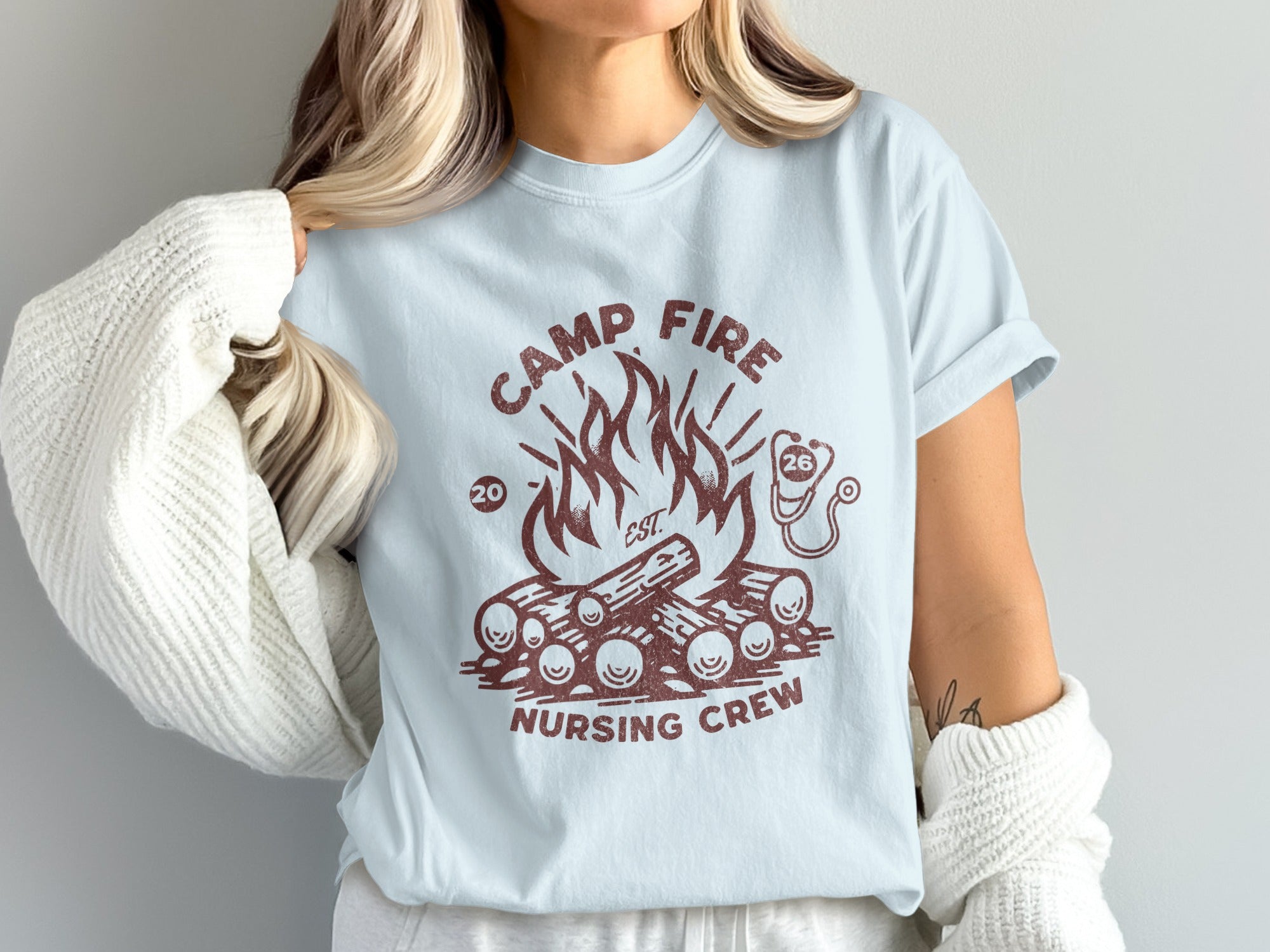 Camp Fire Nursing Crew t-shirt with wood fire and stethoscope graphic.