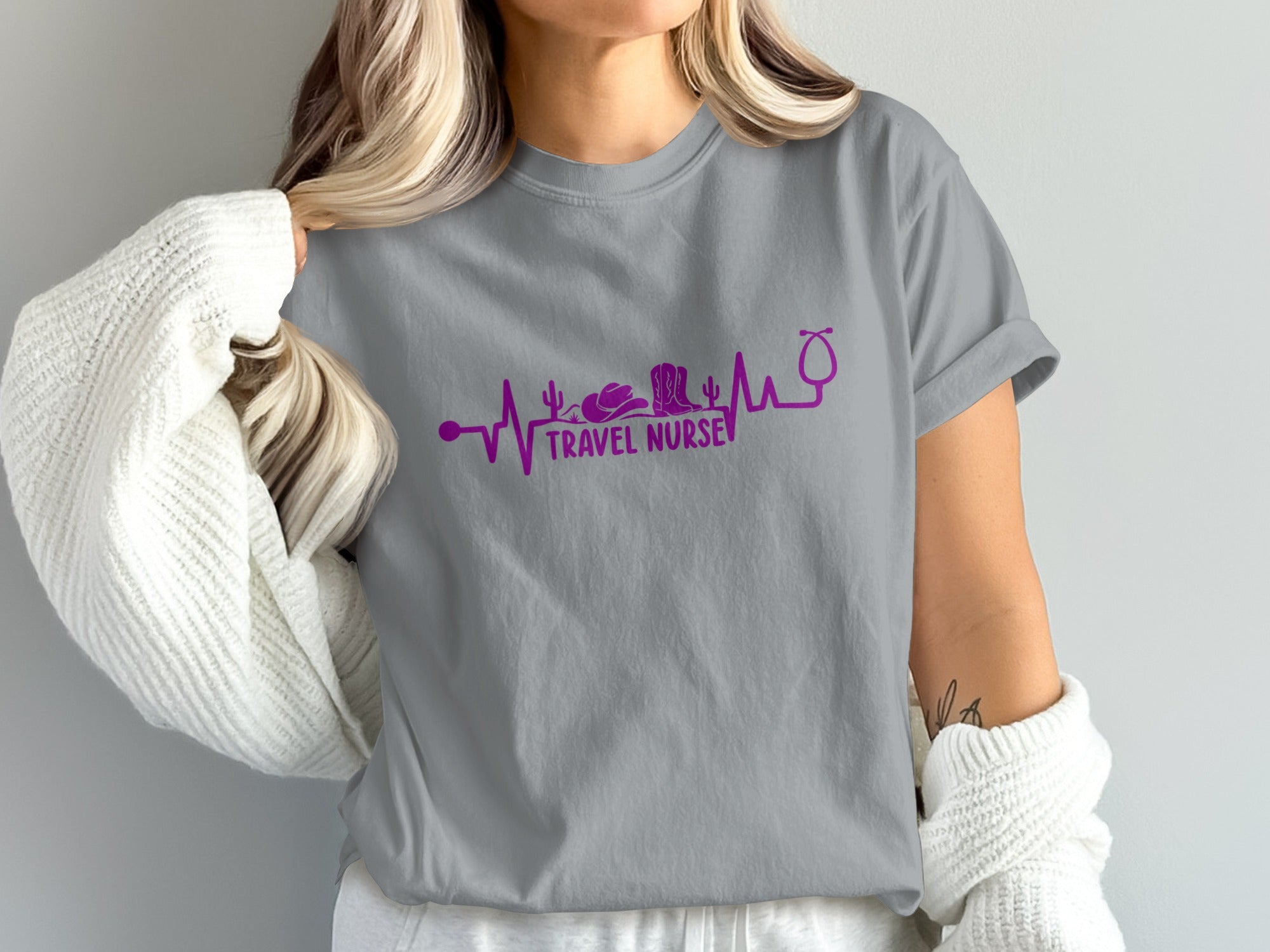 Gray t-shirt with a purple heartbeat graphic featuring a cactus, cowboy boot, and stethoscope.