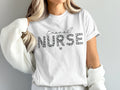 White t-shirt with "Travel Nurse" in leopard print and a small heart.