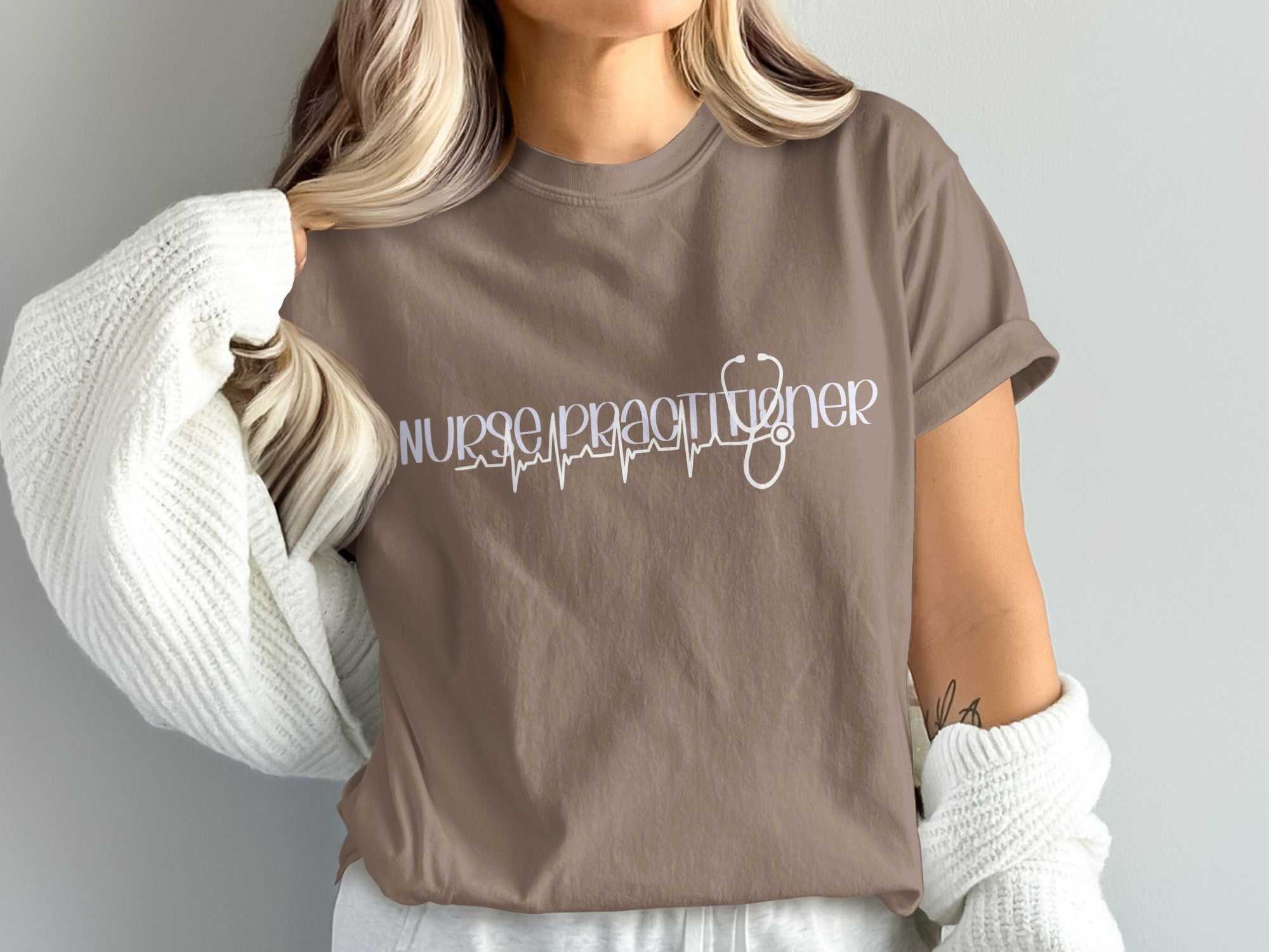 Brown t-shirt with "Nurse Practitioner" text and stethoscope heartbeat graphic.