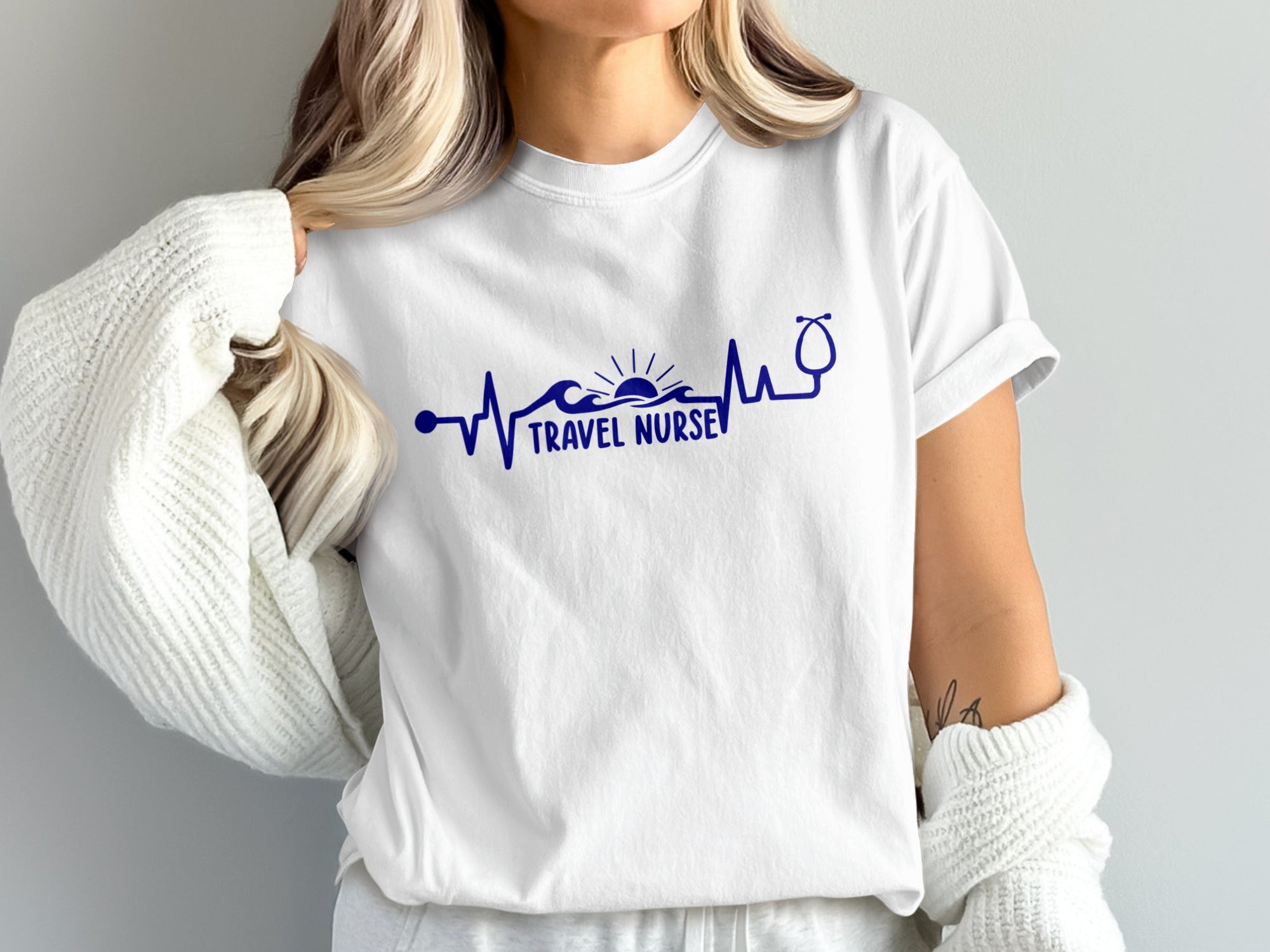 White t-shirt with navy blue "Travel Nurse" text and heartbeat graphic.