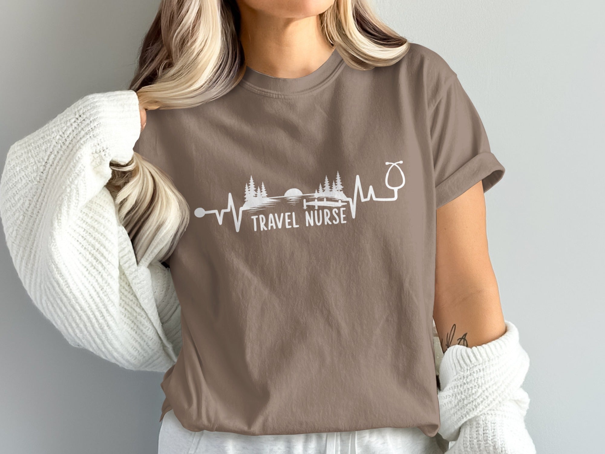 Brown t-shirt with "TRAVEL NURSE" and a heartbeat-like graphic of a stethoscope and trees.