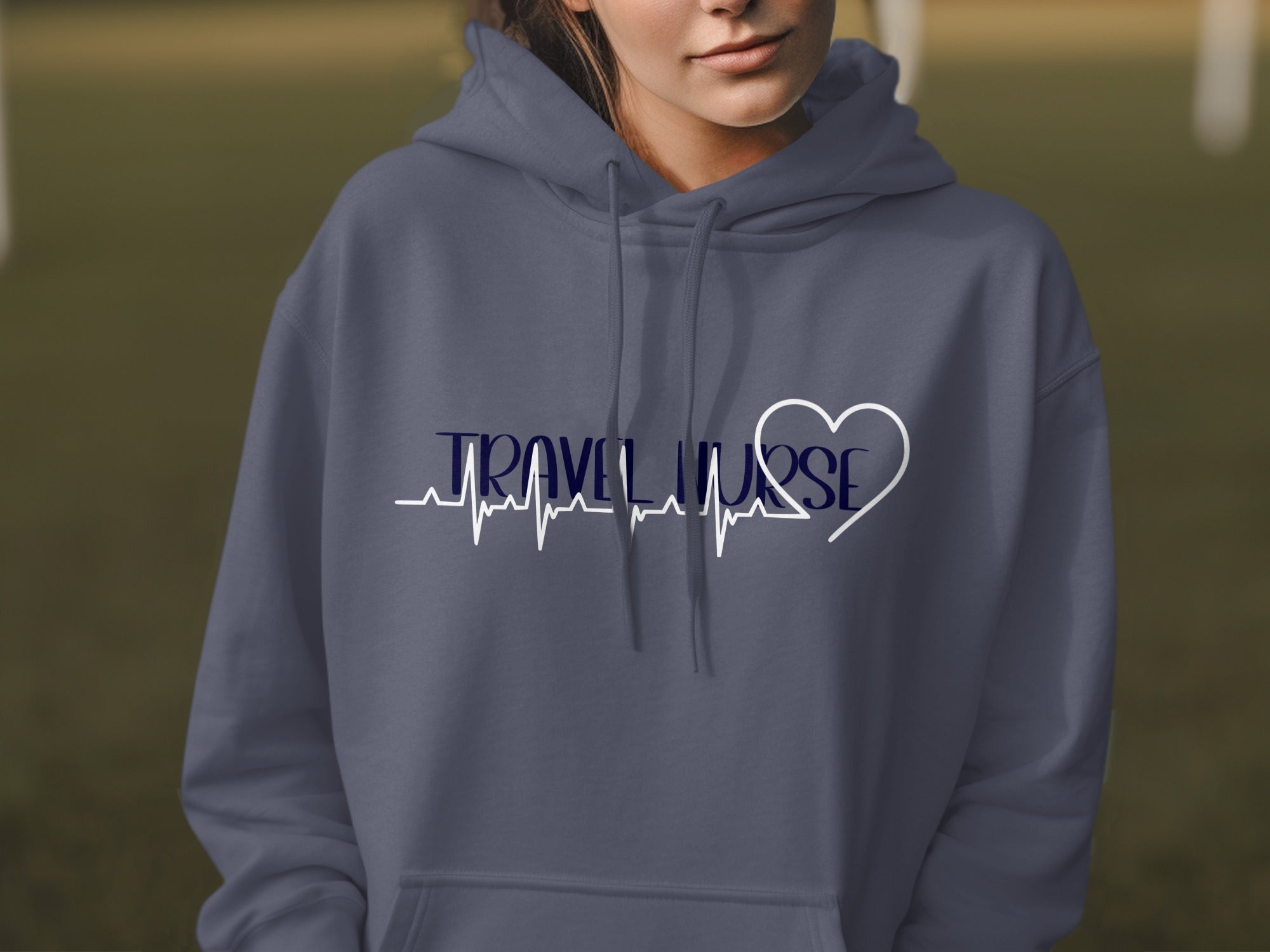 Dark grey hoodie with "TRAVEL NURSE" text and a heart over a heartbeat line.