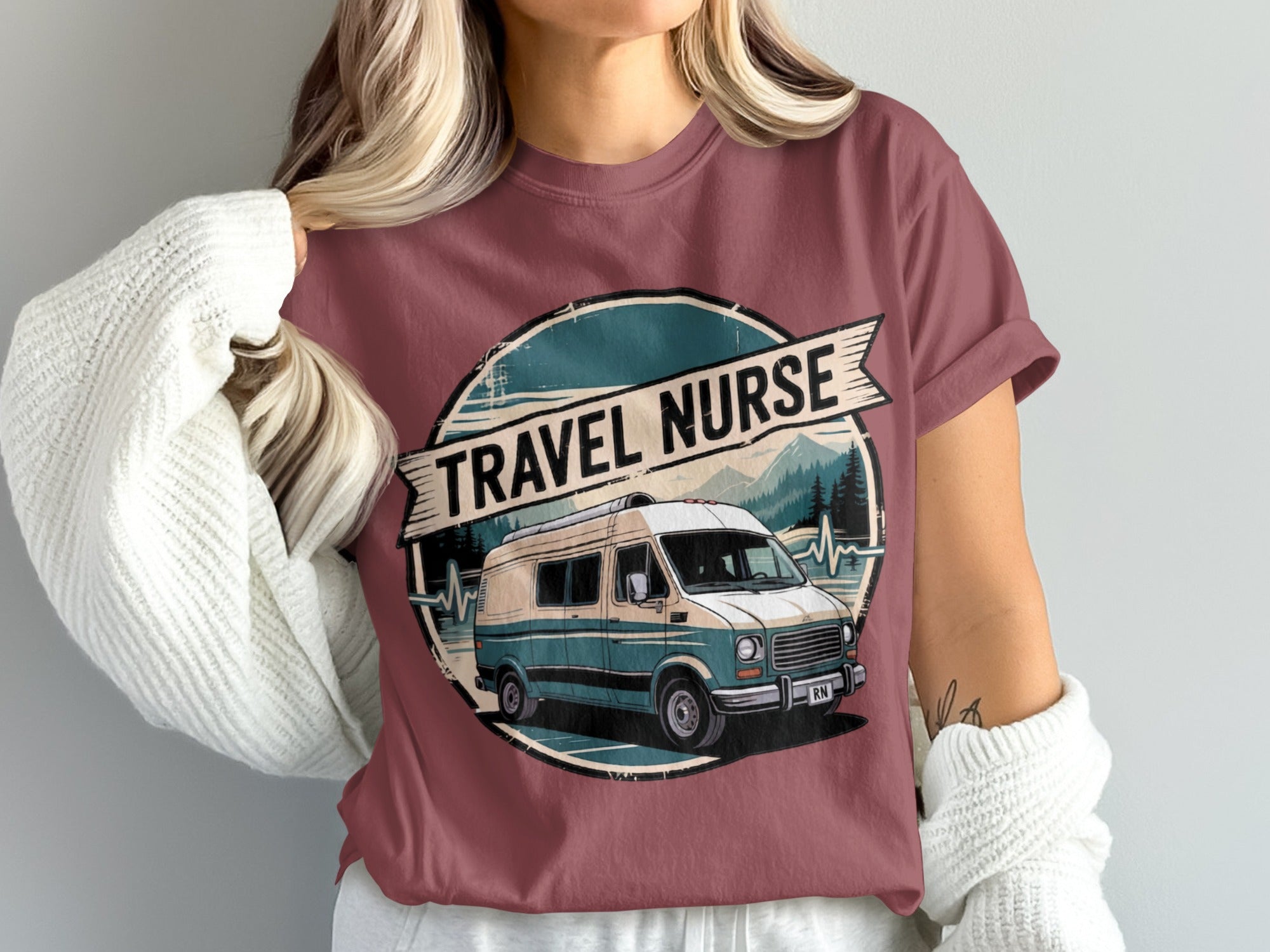 Vans, mountains, and a nurse RN graphic on a dark pink t-shirt.