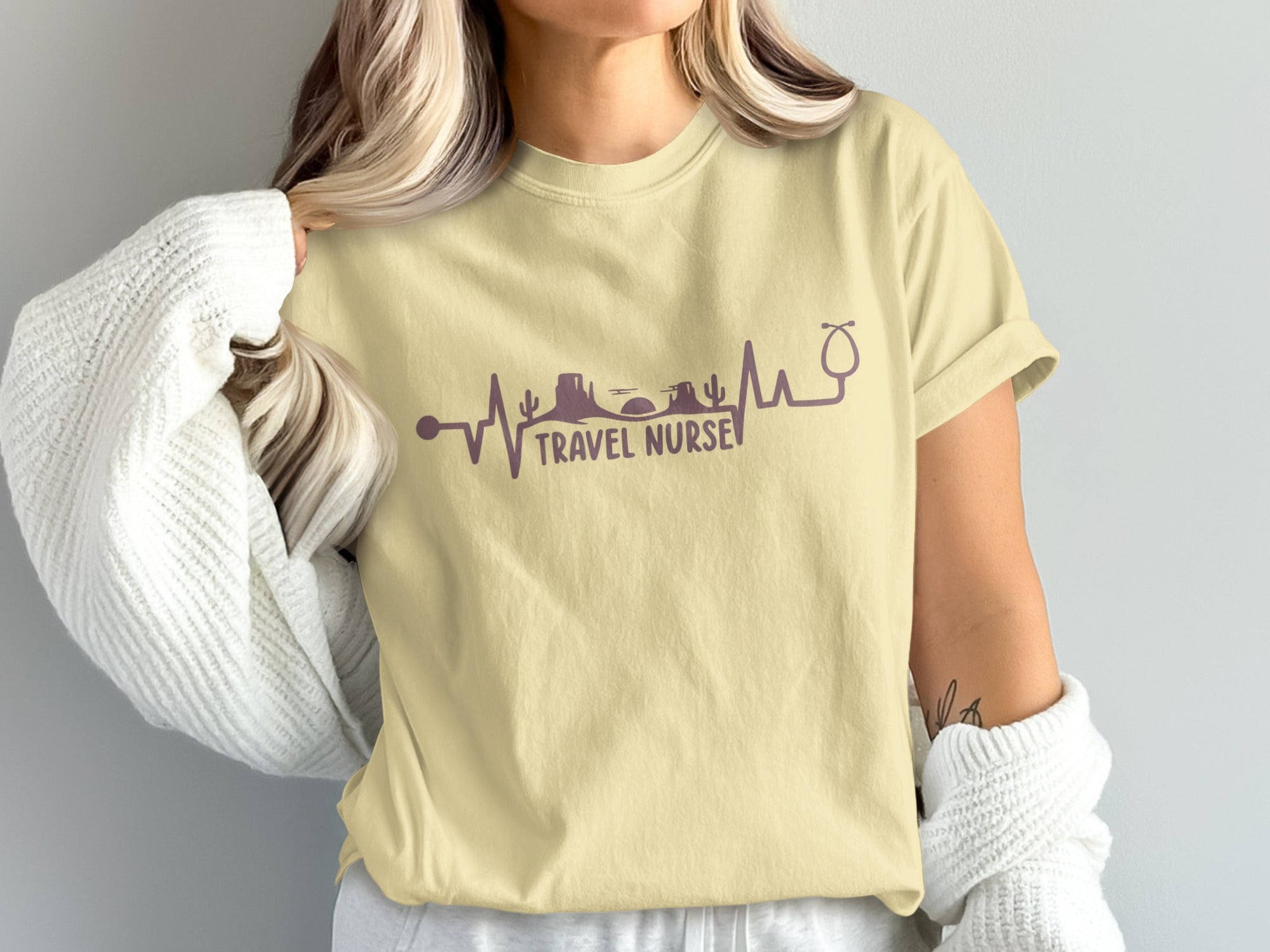 Pale yellow t-shirt with a purple heartbeat and skyline design.
