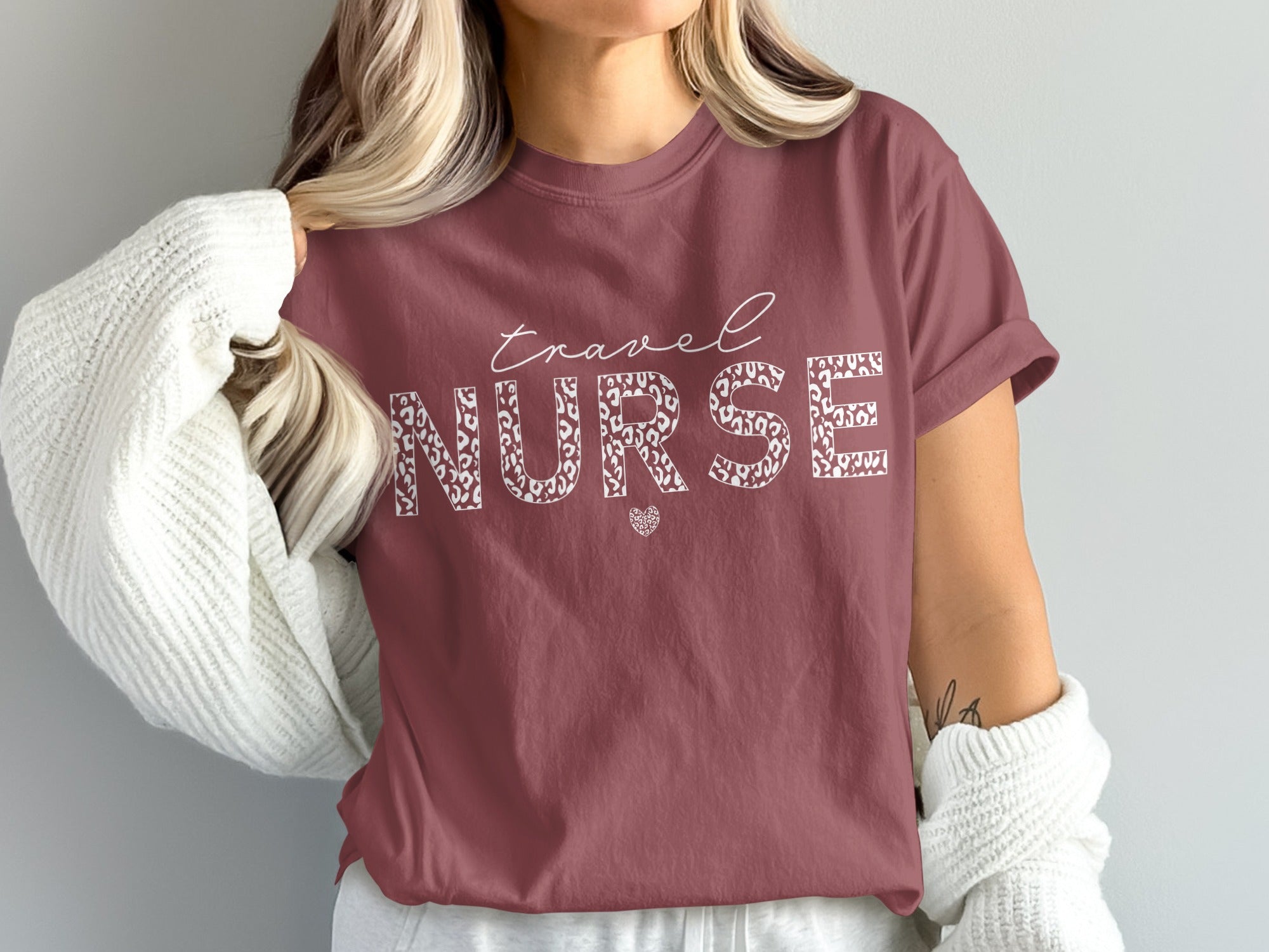 Maroon t-shirt with "travel NURSE" in white leopard print and a heart accent.