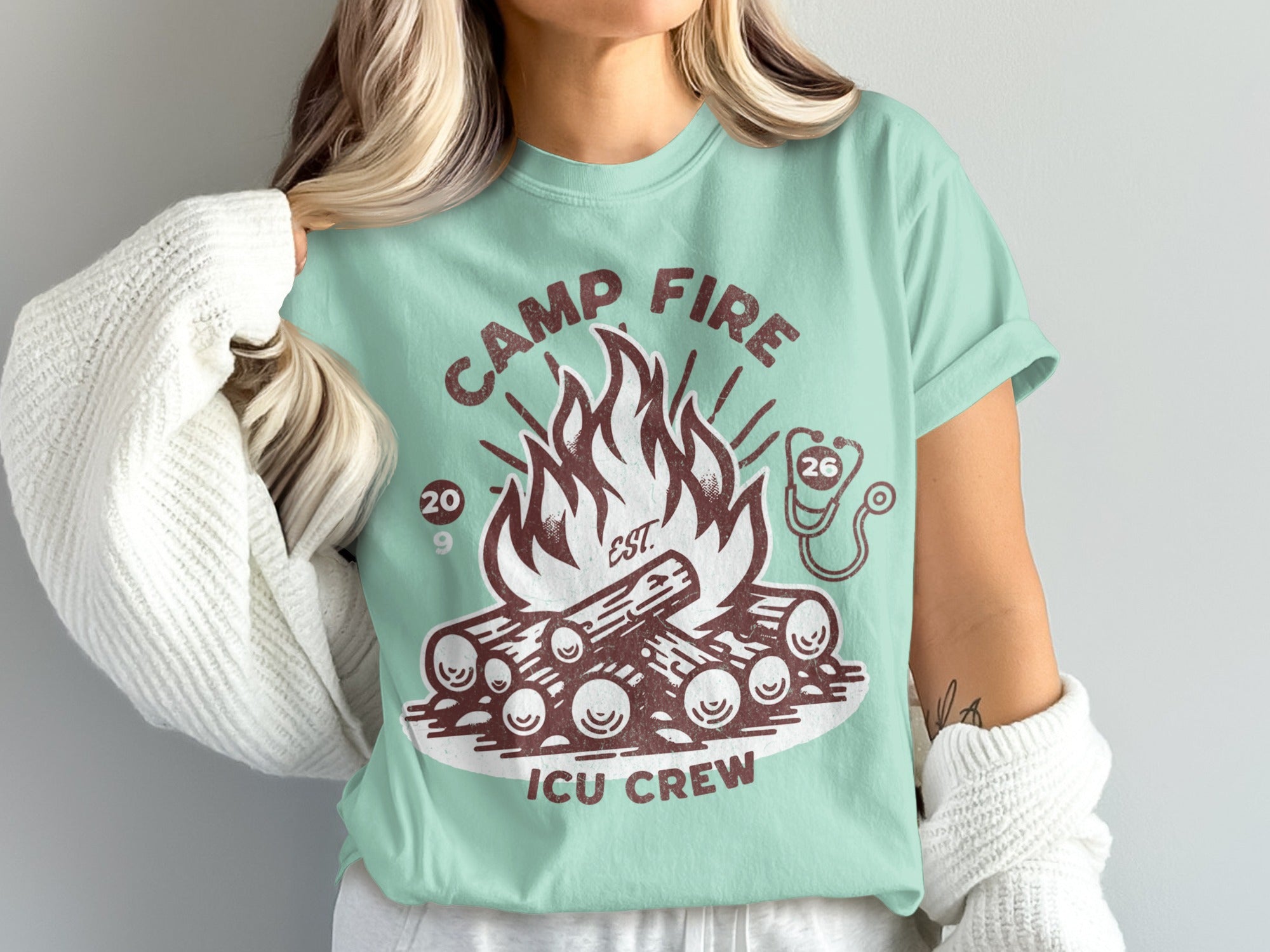 Camp Fire ICU Crew t-shirt with campfire and stethoscope graphic.