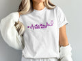 White t-shirt with purple heartbeat line graphic and "Travel Nurse" text.