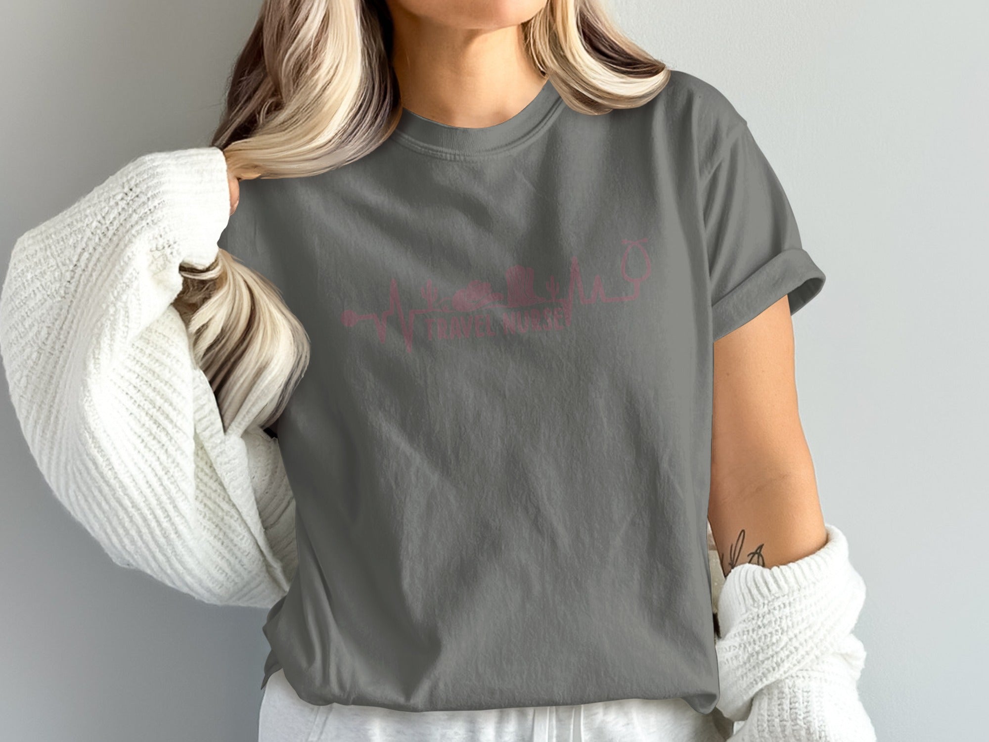 Grey t-shirt with pink travel nurse heartbeat graphic.